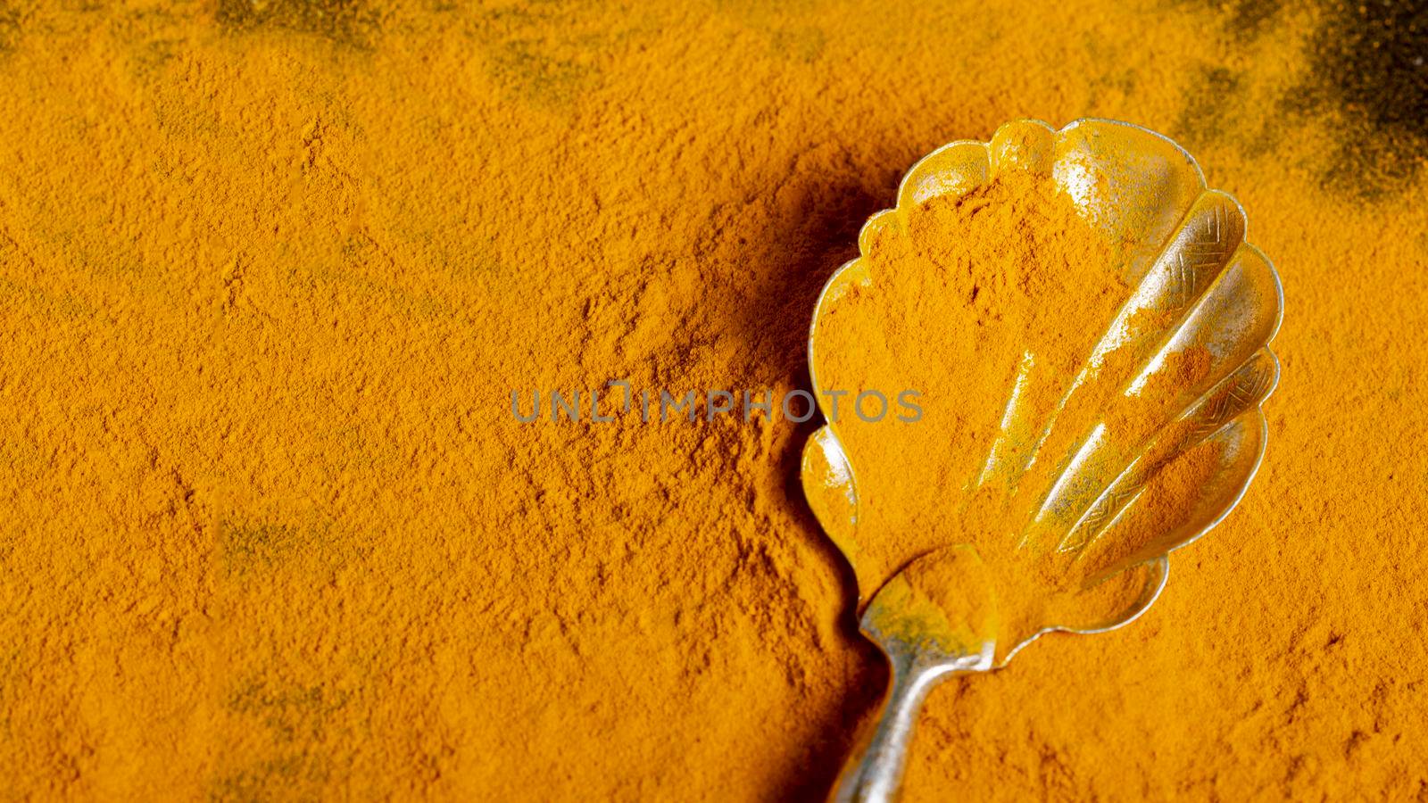 top view spoon with turmeric with copy space by Zahard