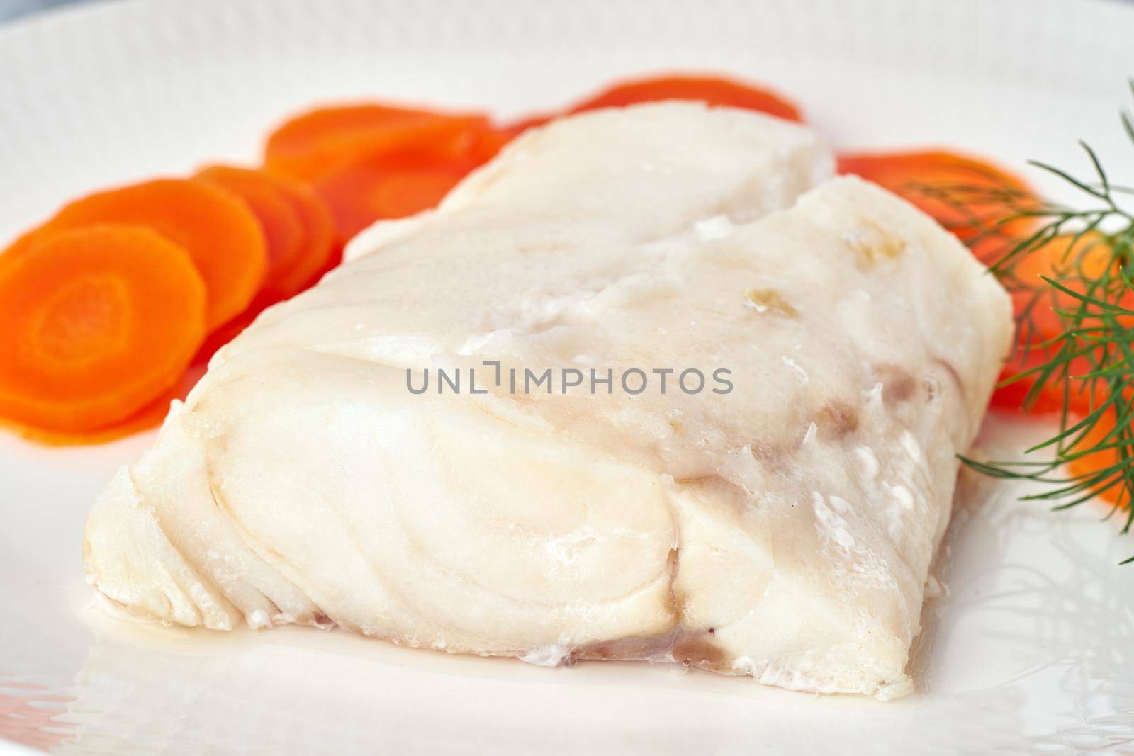 steamed codfish full of vitamins with carrot and dill, healthy diet, fodmap dash and paleo