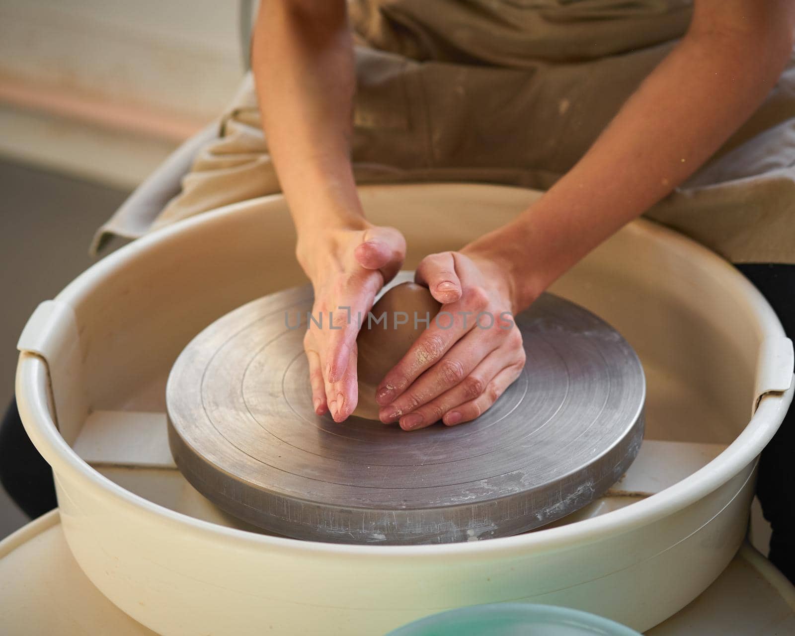 Woman making ceramic pottery on wheel, creation of ceramic ware. Concept for small business or hobby