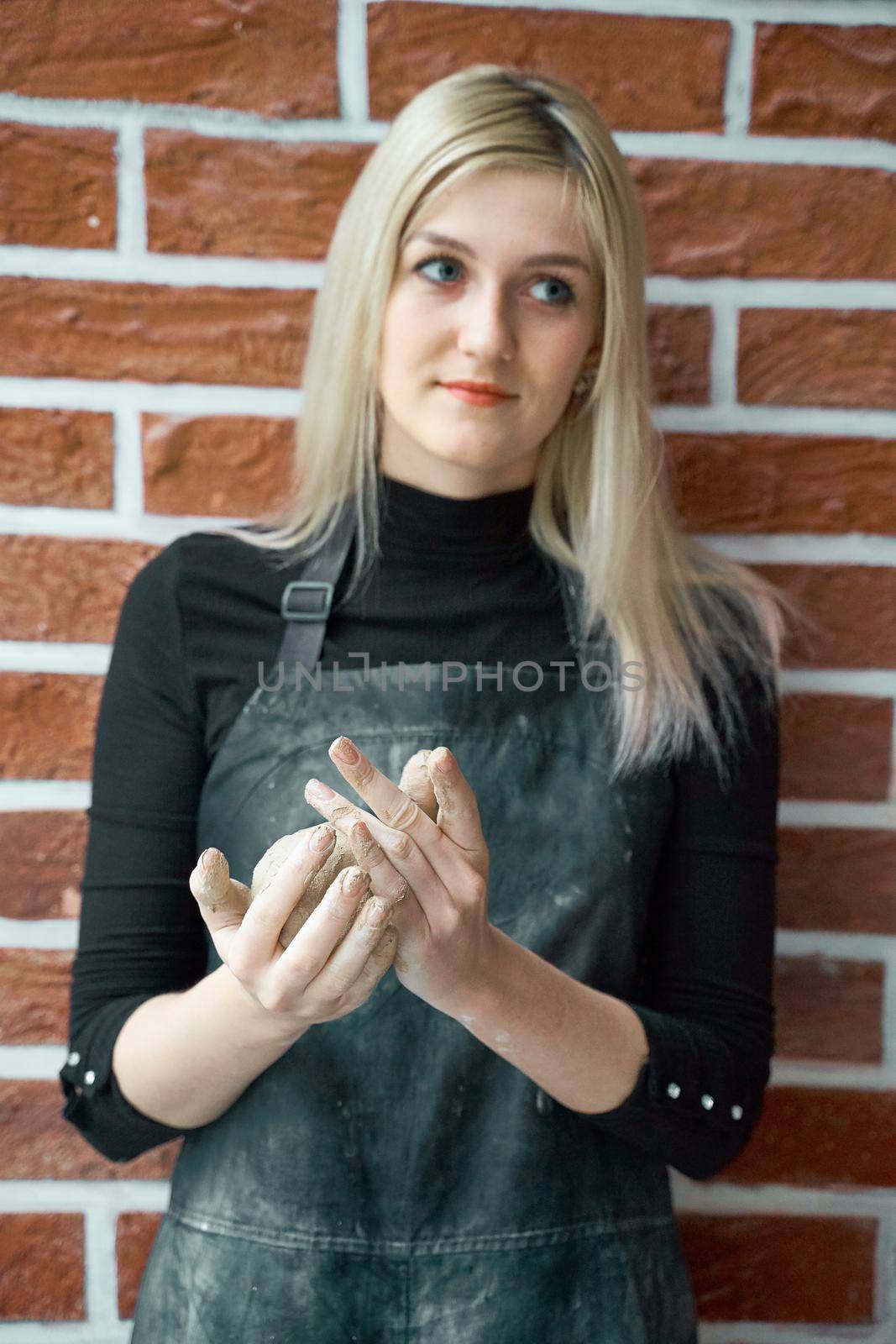 Happy woman making ceramic bowl in hand. Creative hobby concept. Earn extra money, side hustle, turning hobbies into cash, passion into a job, vertical