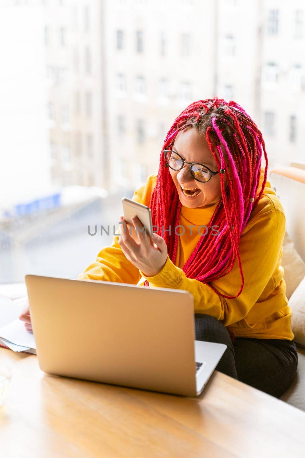 Digital nomad concept. Girl freelancer remotely working on laptop in cafe, coworking. by NataBene