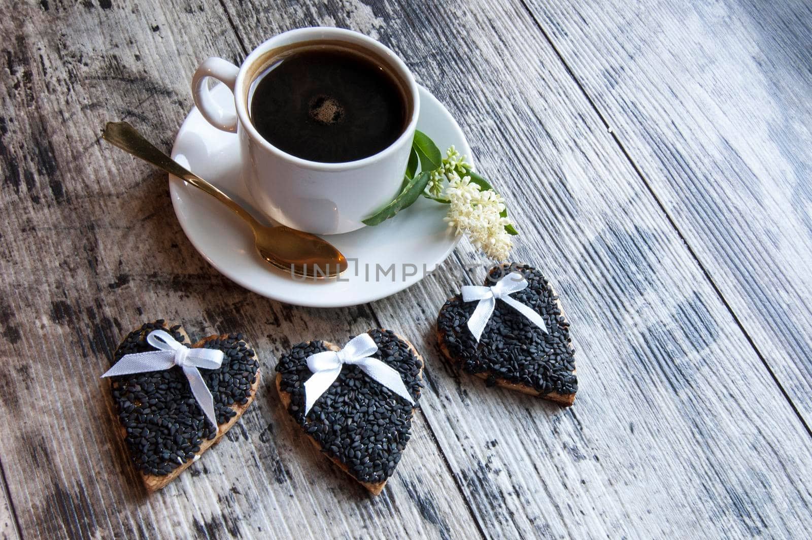 Cookies for the wedding decorated black sesame with a cup of coffee served with a golden spoon. From the series "Wedding Cookies"