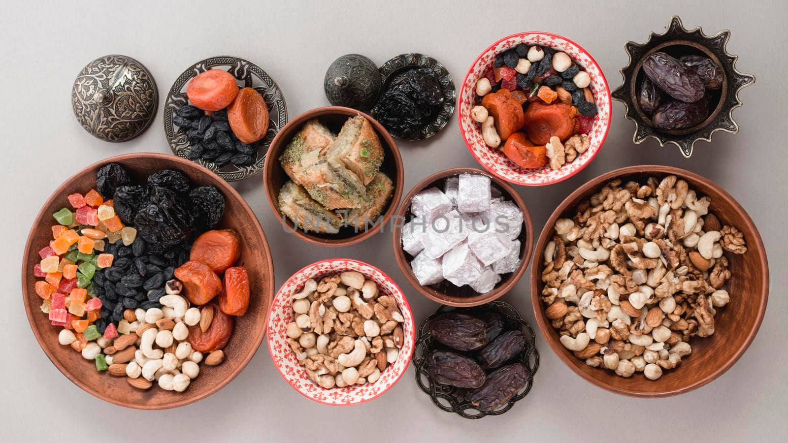 elevated view traditional sweets dried fruits nuts white background by Zahard