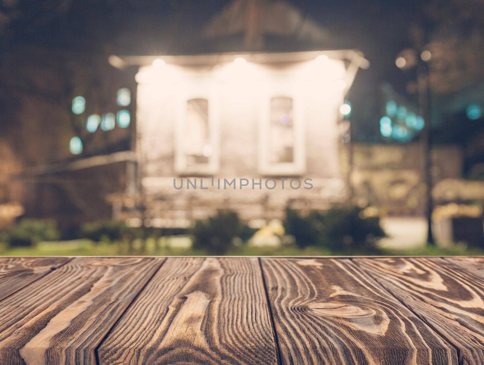 Wooden board empty table top on of blurred background. Perspective brown wood table over blur in coffee shop background - can be used mock up for montage products display or design key visual layout.