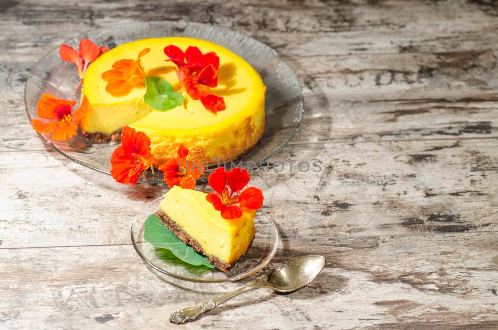 Pumpkin cheesecake decorated with fresh flowers. From the series "Pumpkin Cheesecake"