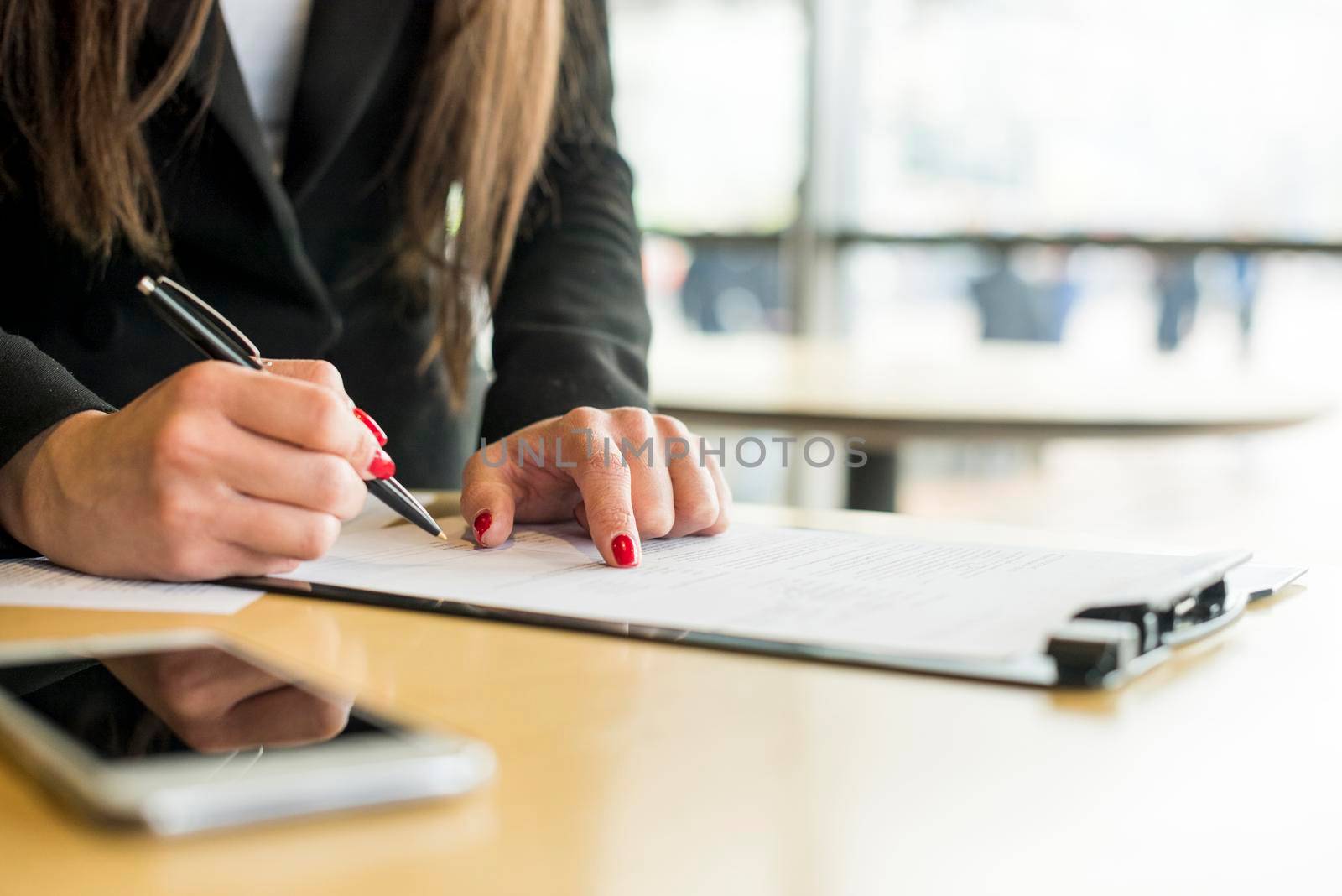 brunette businesswoman writing document