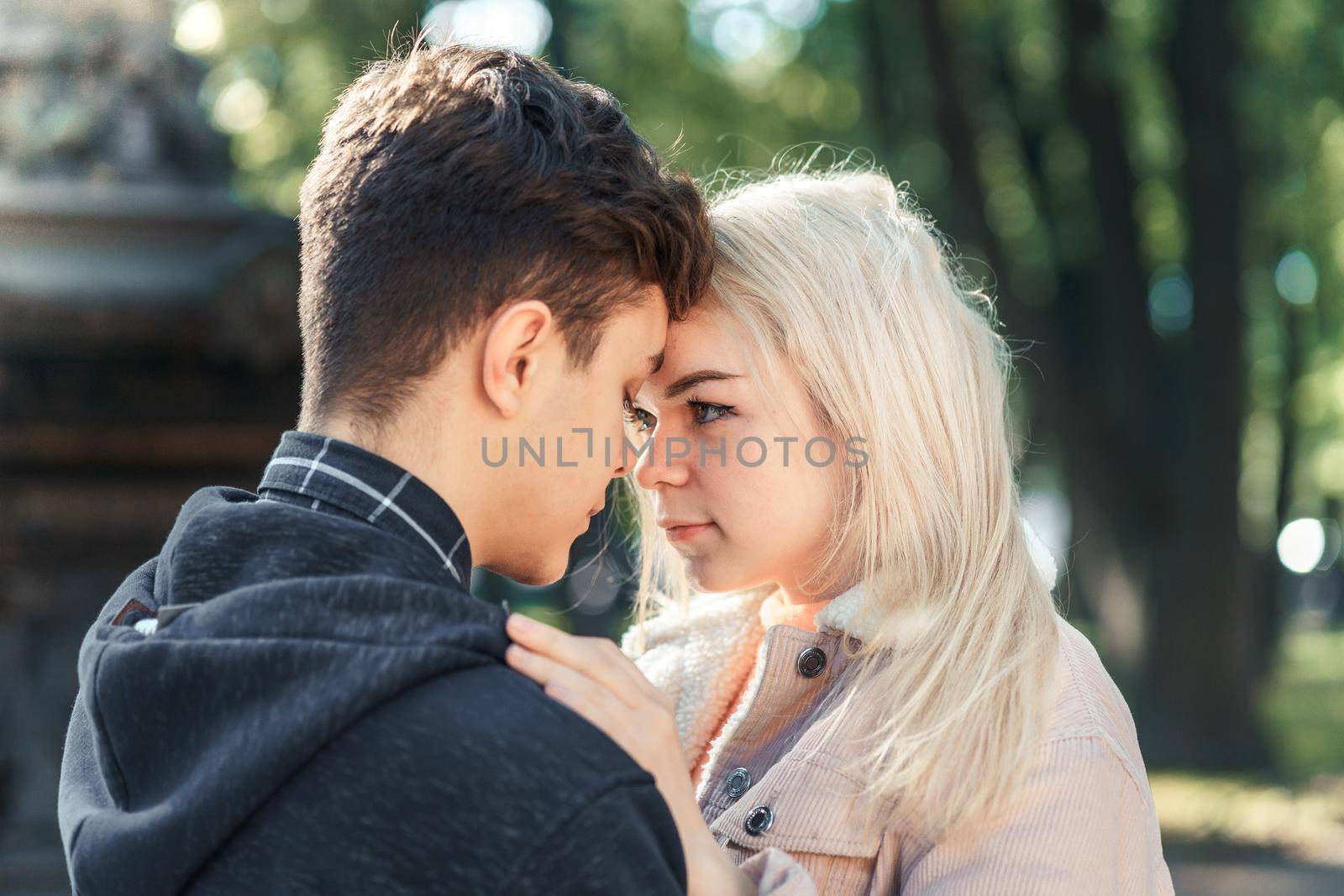 Girlfriend and Boyfriend are looking at each other in the park, concept of love and happiness by NataBene