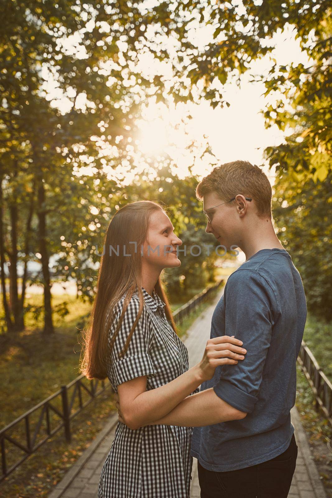 Girlfriend and Boyfriend are looking at each other in the park, concept of love and happiness by NataBene