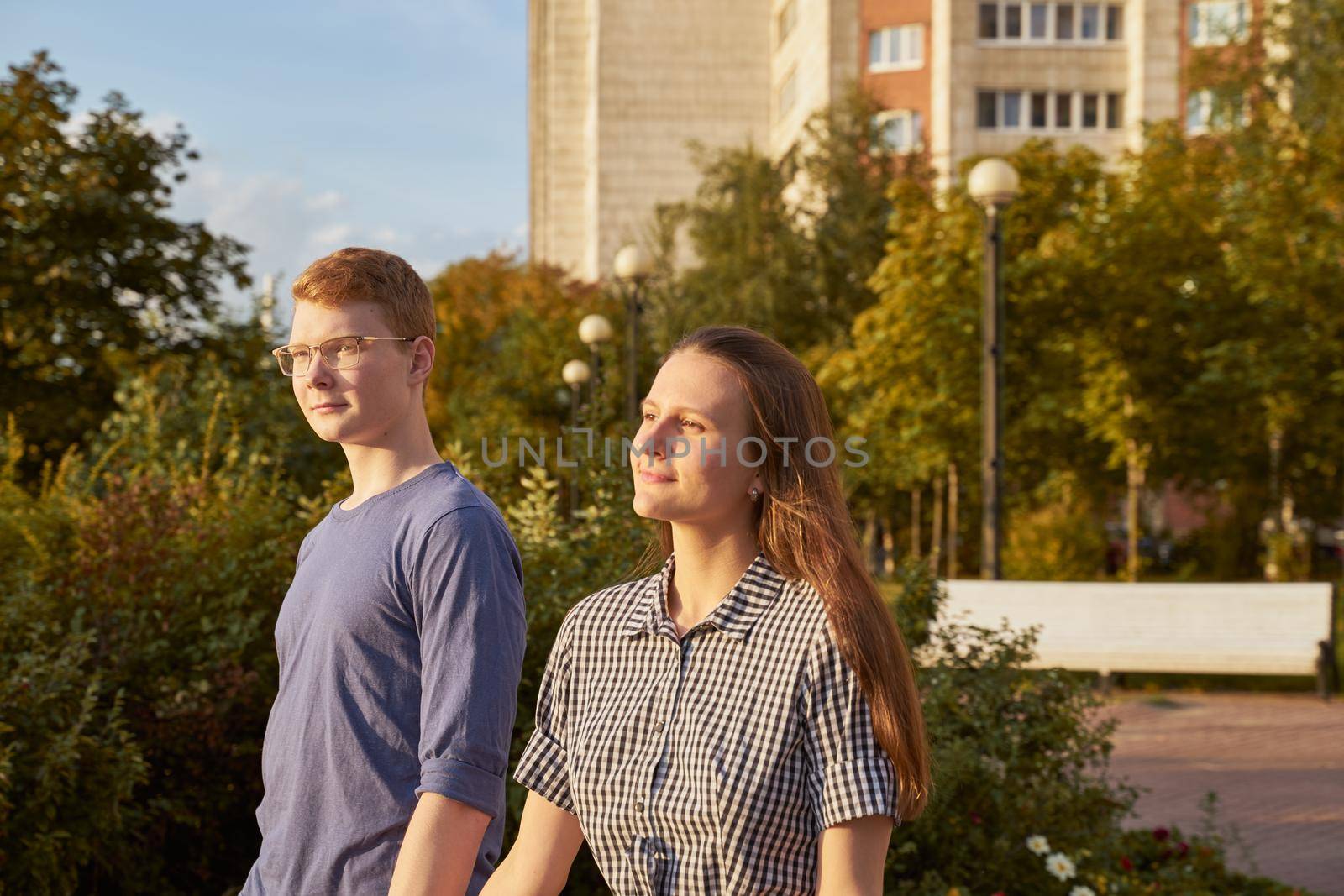 girlfriend and boyfriend walking and holding hands, copy space, park