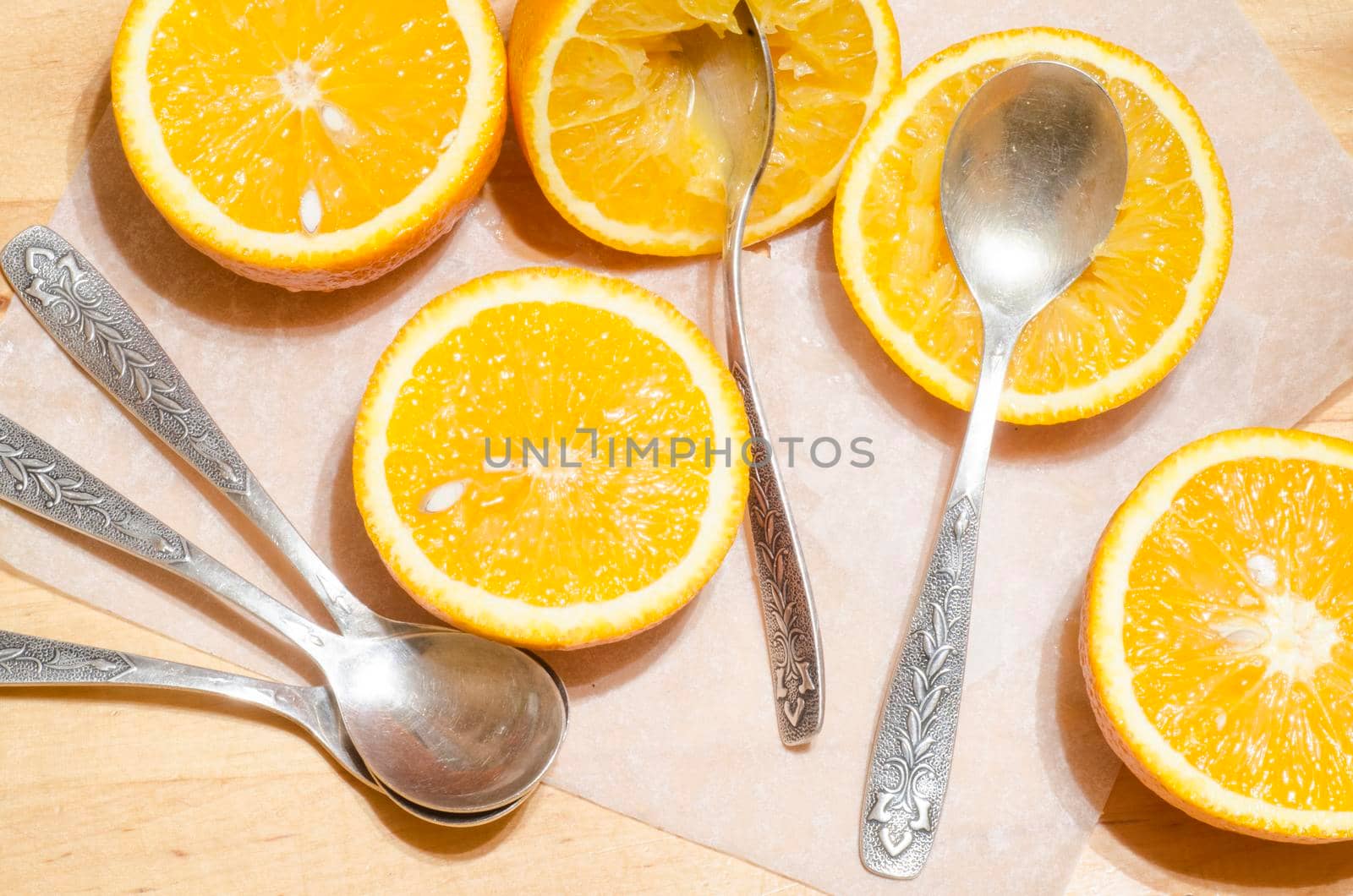 Oranges and teaspoons on baking paper. Process of making pumpkin muffins/ From the series "Cooking pumpkin cupcakes"