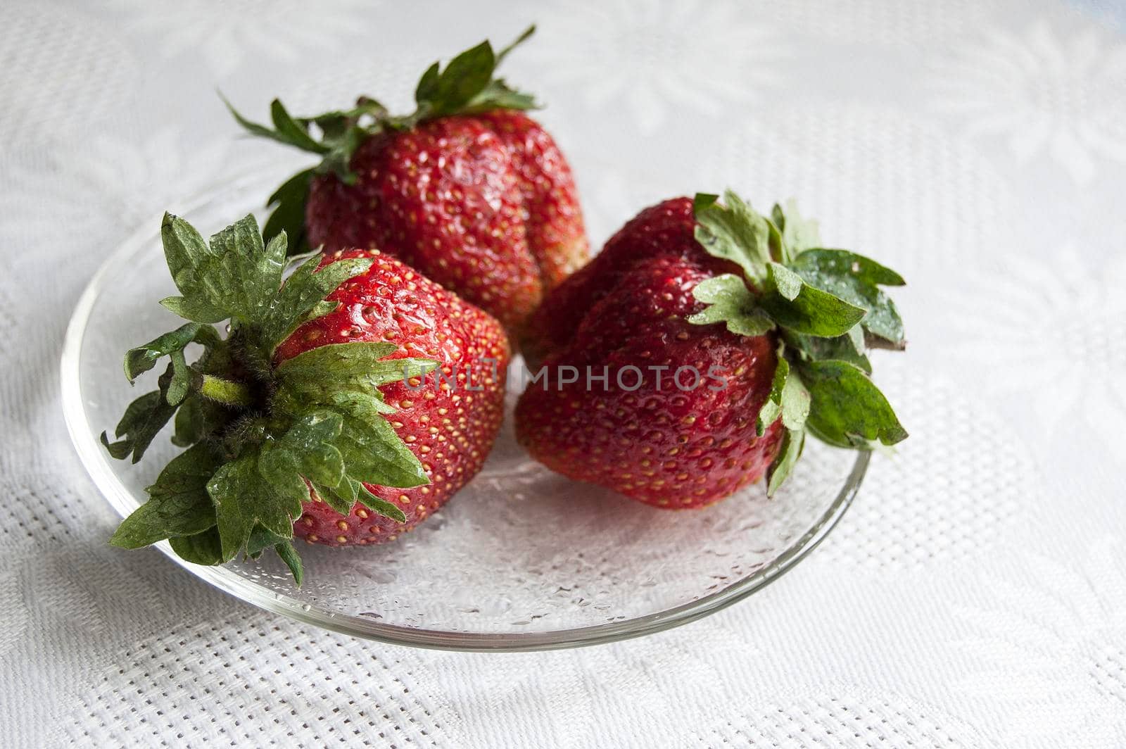 Fresh strawberry on a glass plate