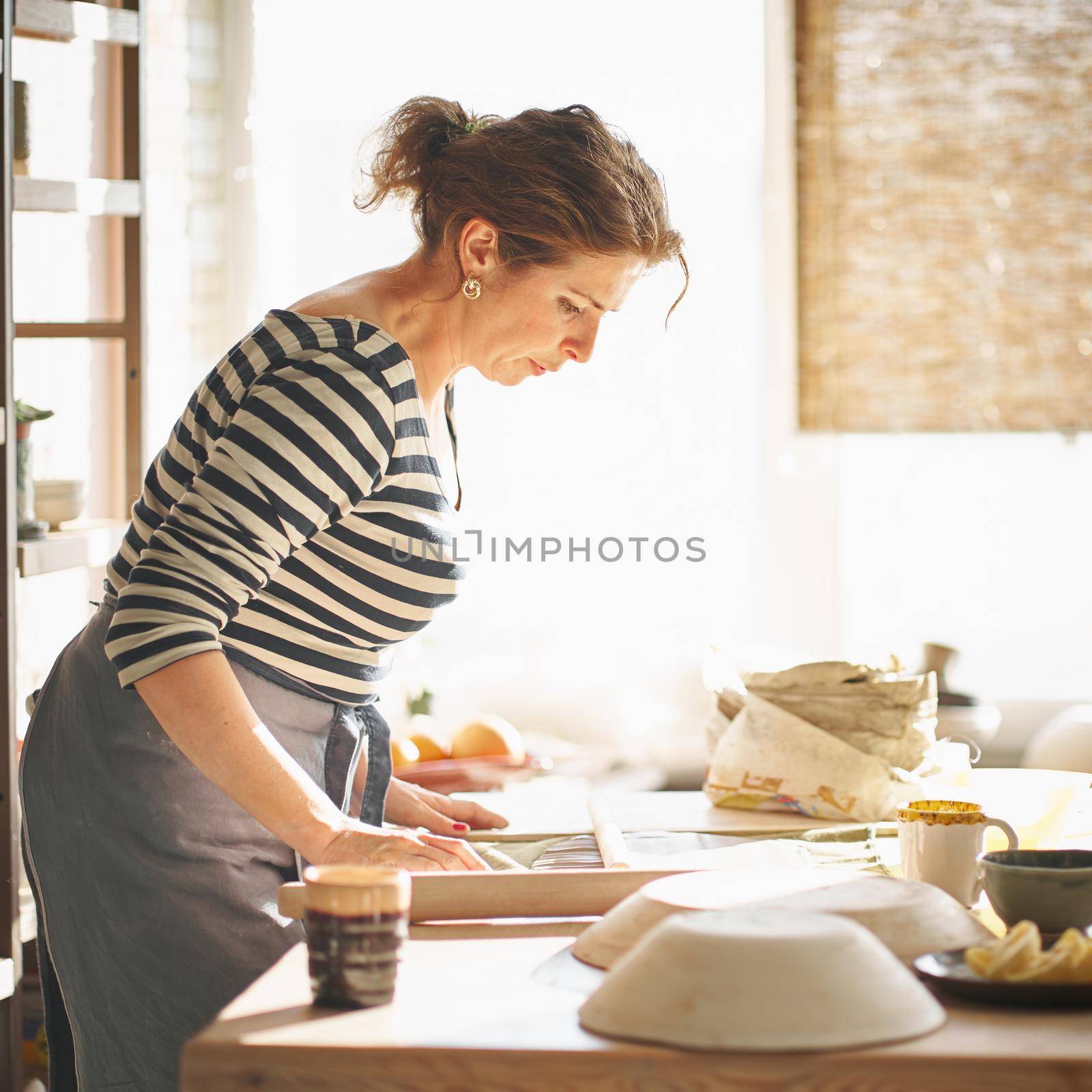 Woman freelance, business, hobby. Woman making ceramic pottery by NataBene