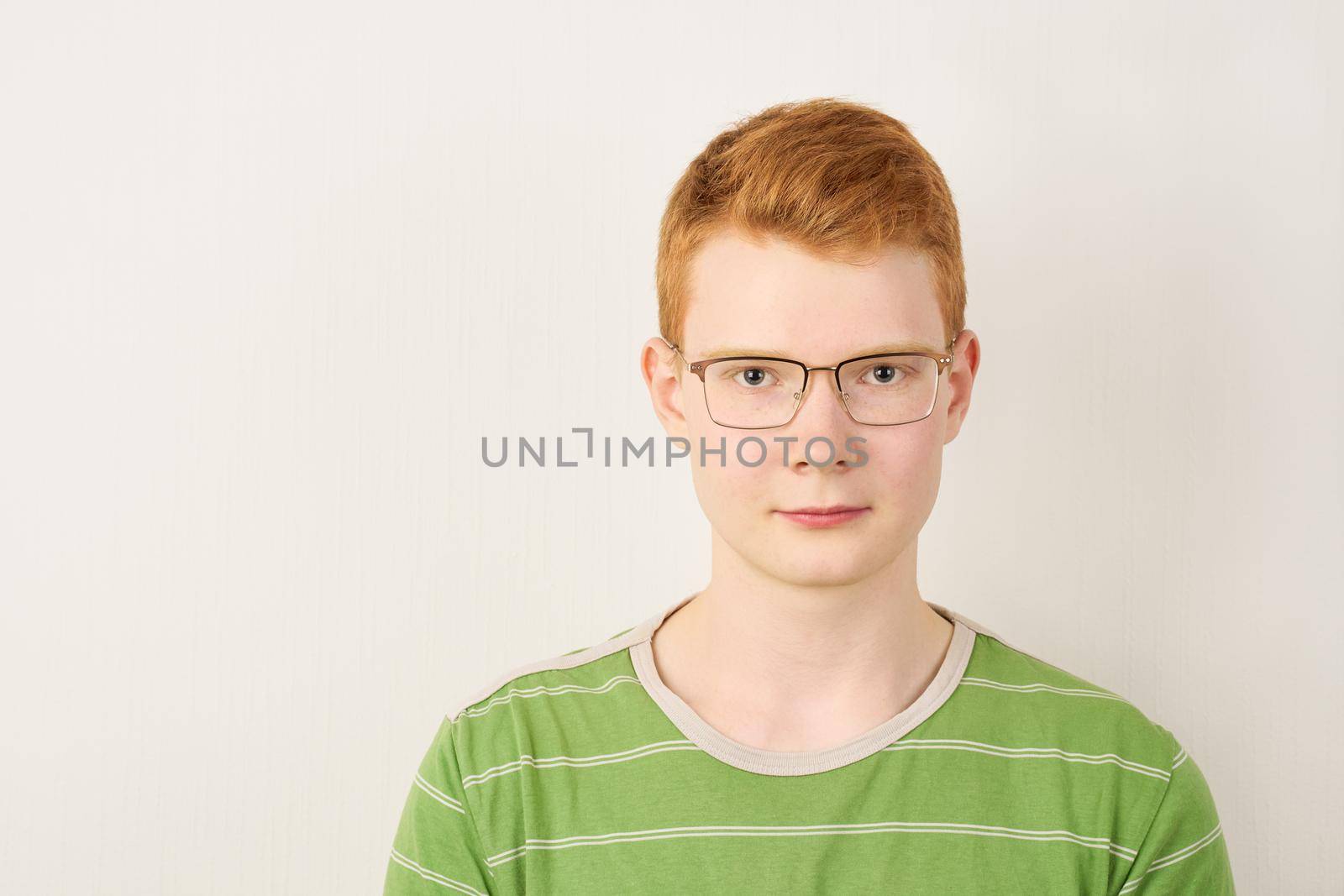 Redhead young man with glasses on white background by NataBene