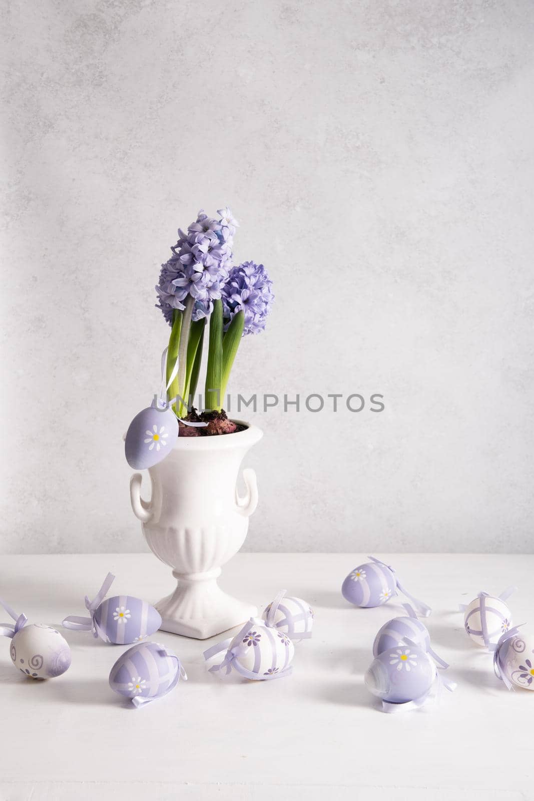 Easter eggs and Lilac hyacinth in a vase, spring still life, copy space. High quality photo