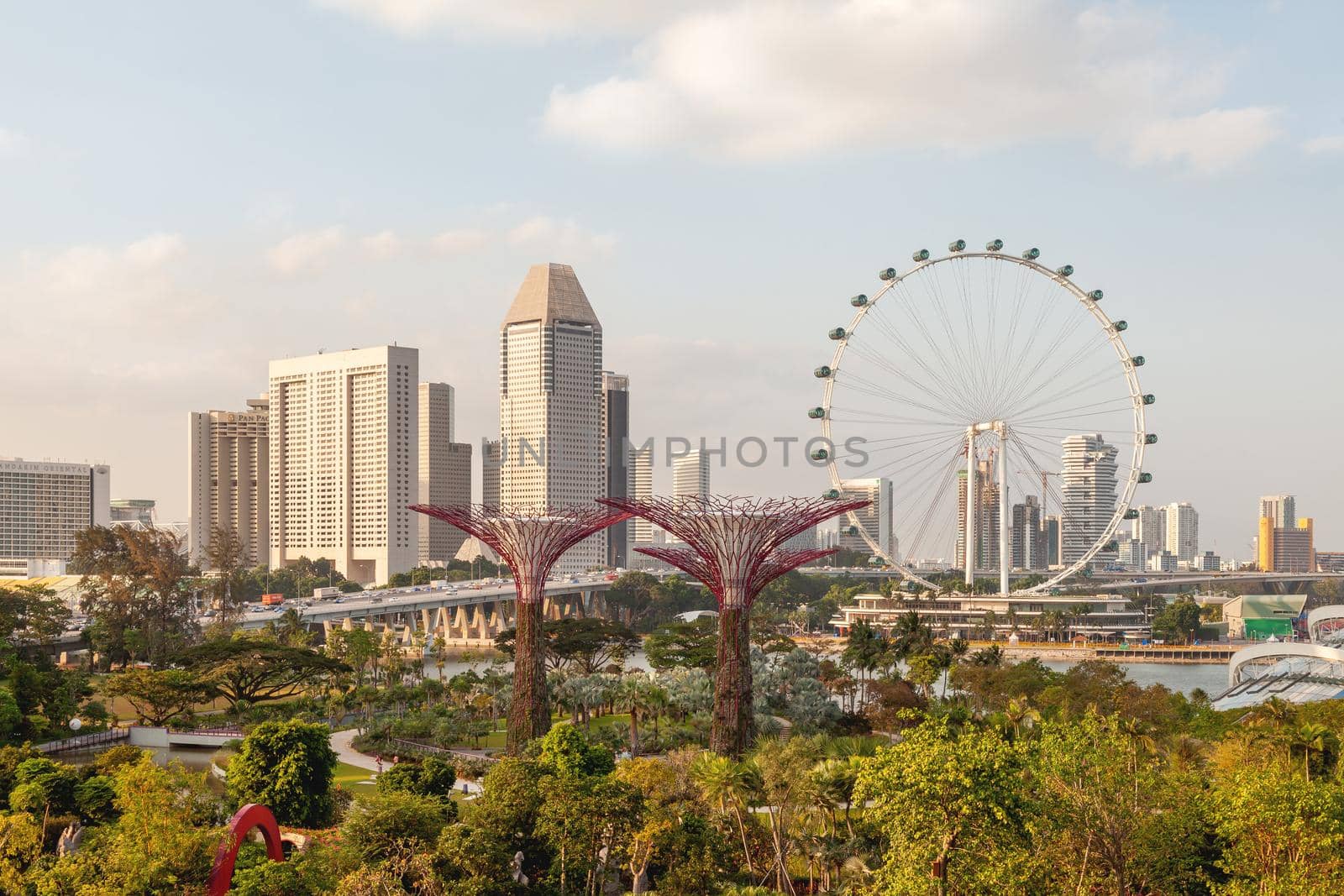 SINGAPORE, SINGAPORE - January 17, 2013. Aerial panorama view of Gardens by the Bay, Big Wheel attraction and business skyscrapers.