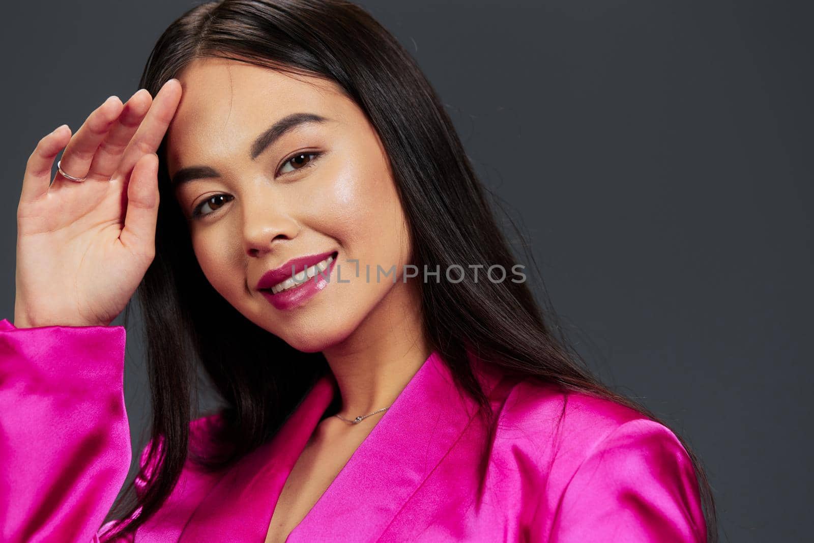 pretty woman in a pink mini dress luxury Gray background. High quality photo