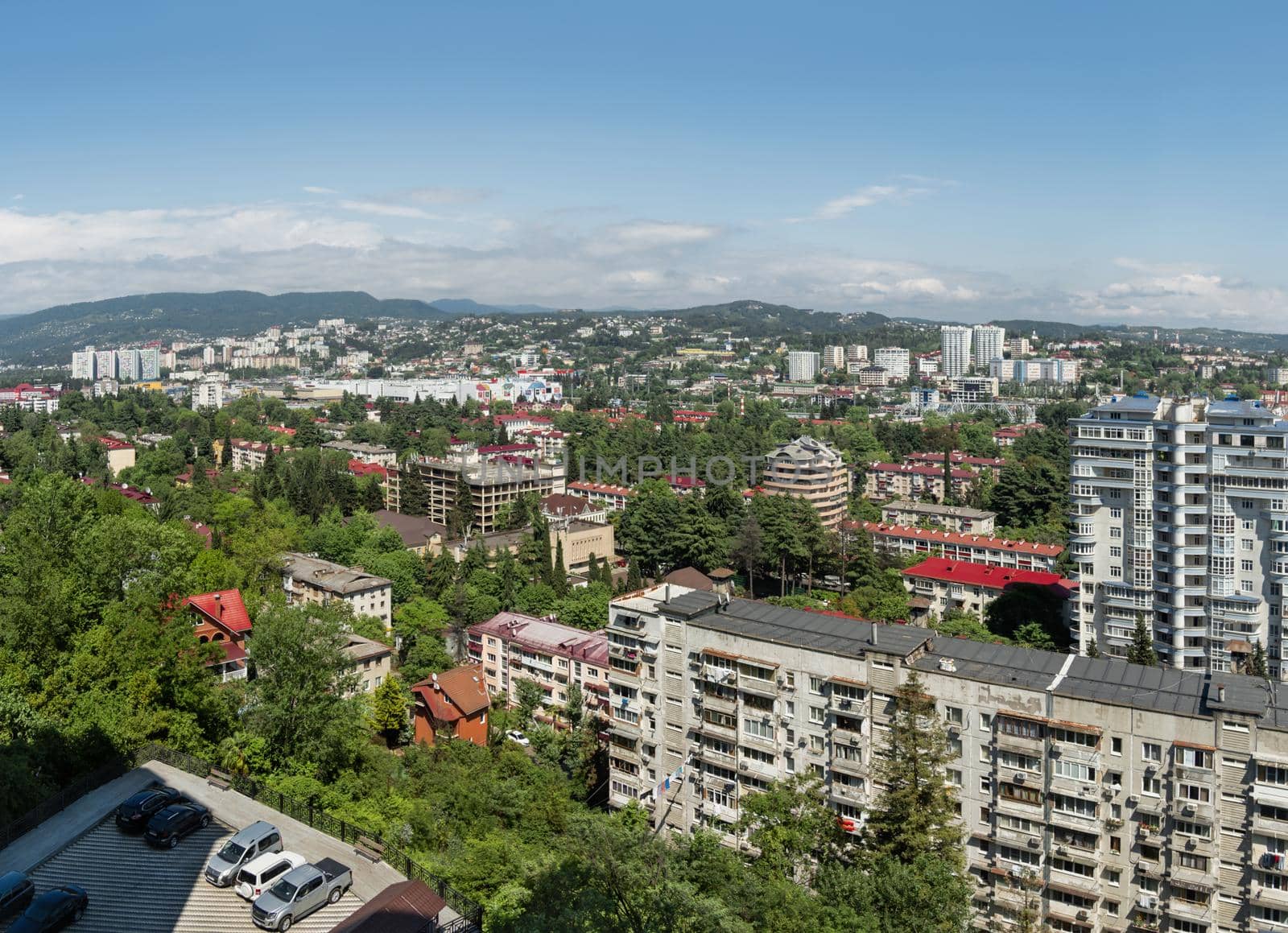 SOCHI, RUSSIA - May 27, 2021. Panorama view of central district of Sochi. Apartment buildings and mountains on horizon. by aksenovko