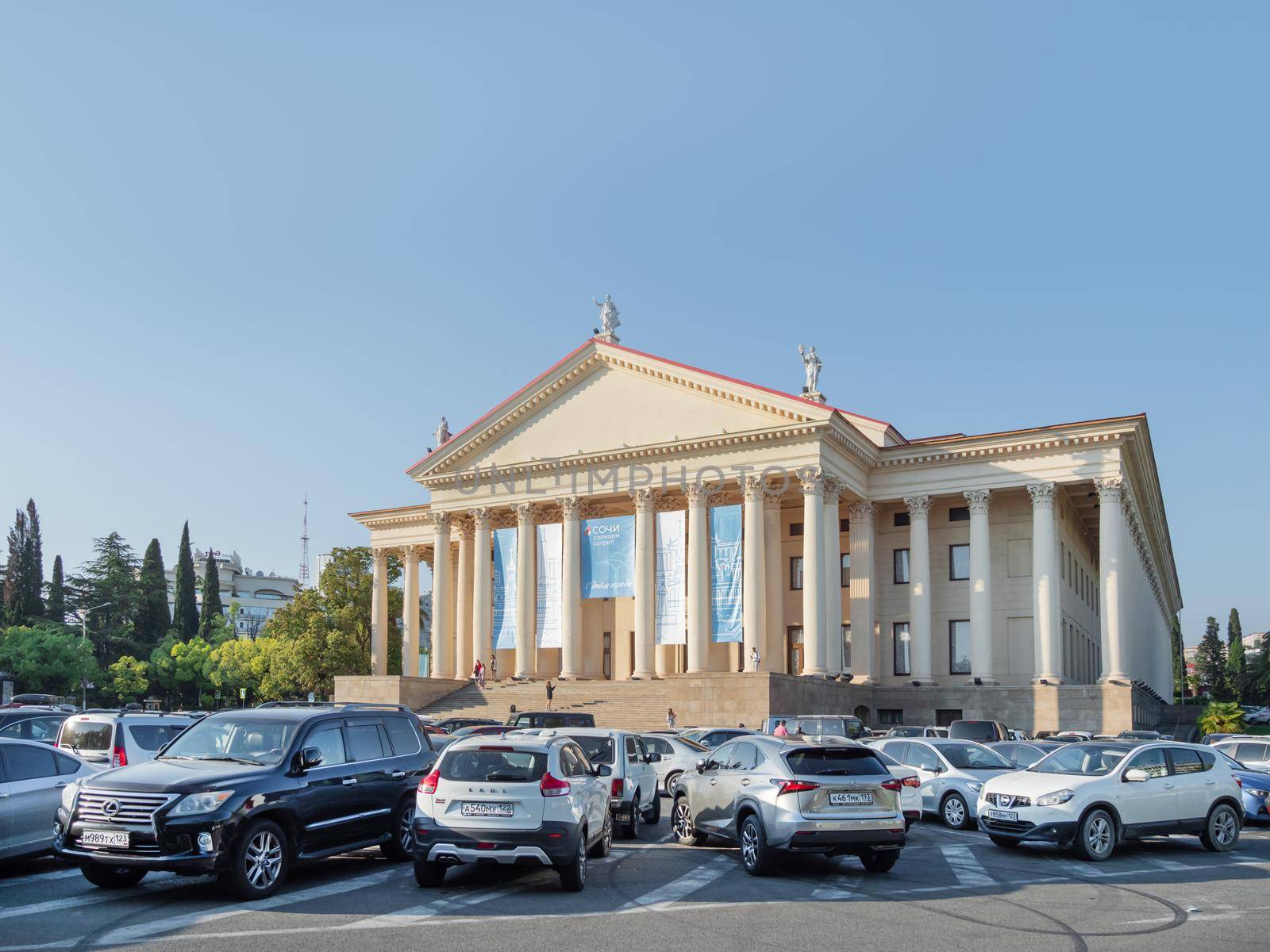 SOCHI, RUSSIA - May 27, 2021. Cars parked in front of Winter Theater or Zimniy Theatre at sunny day. by aksenovko