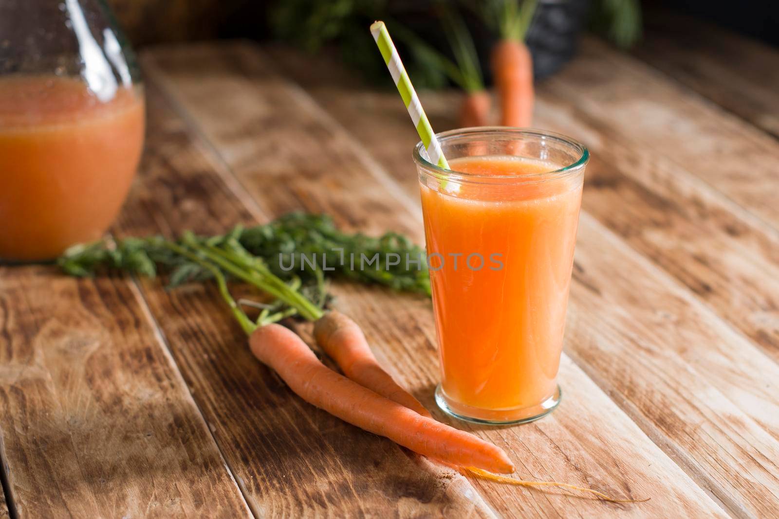 freshly squeezed carrot juice, and raw carrots, vegetarian vegetable vitamin drink, vintage still life concept, fresh carrot juice on wooden background, rustic still life
