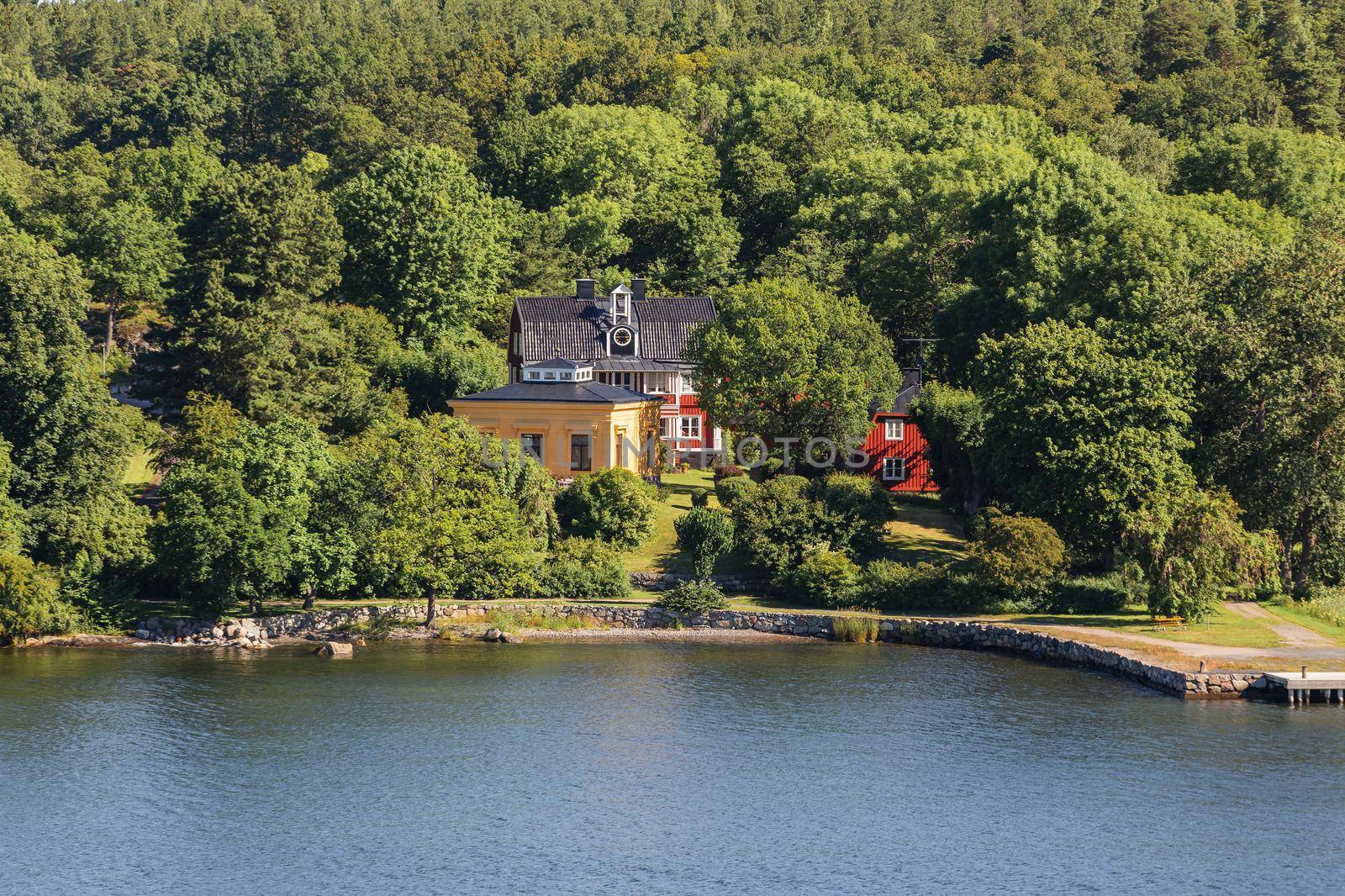 STOCKHOLM, SWEDEN - July 06, 2017. Countryside house on sea coast. Village with colorful houses among trees.