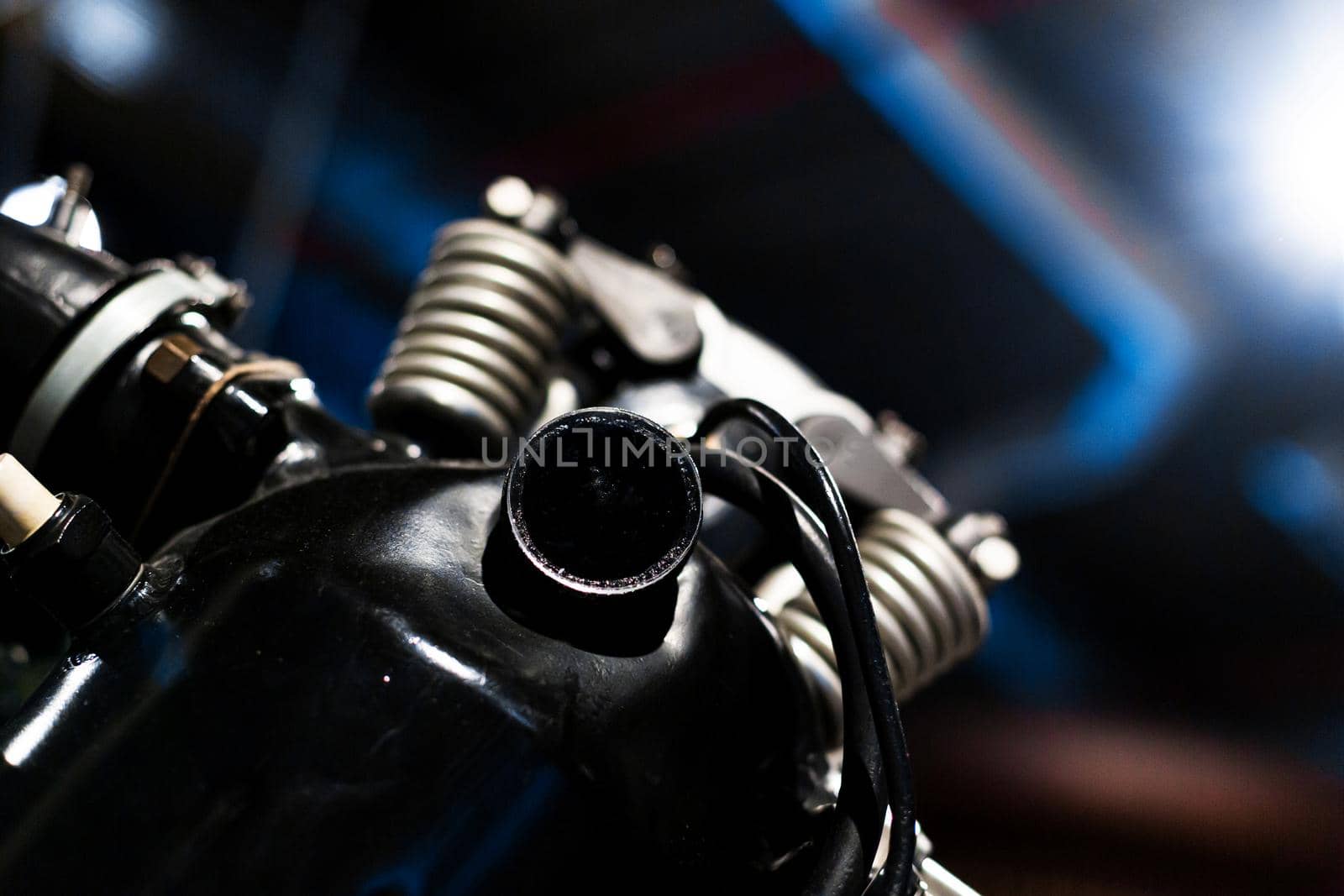 Close-up of a detail of a rare car engine. Metal mechanisms. Automotive industry.
