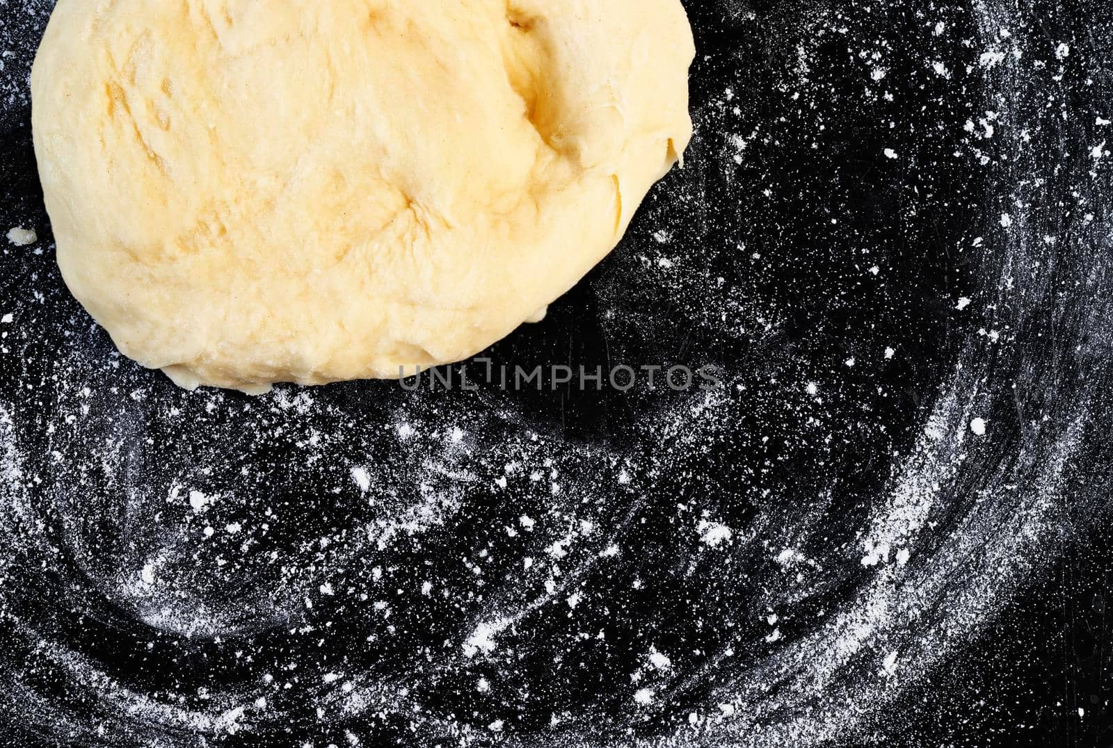 Raw dough on floured black surface ,baker occupation