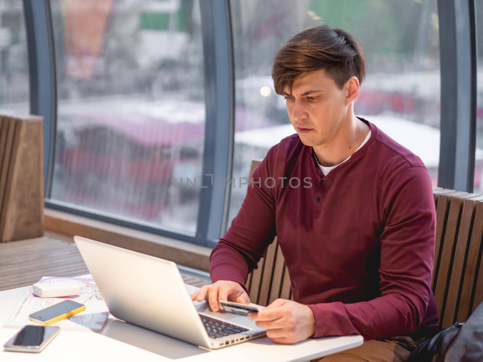 Man is using laptop to pay for online order by credit card. Online shopping or e-commerce. Contactless payment by wireless technologies. by aksenovko