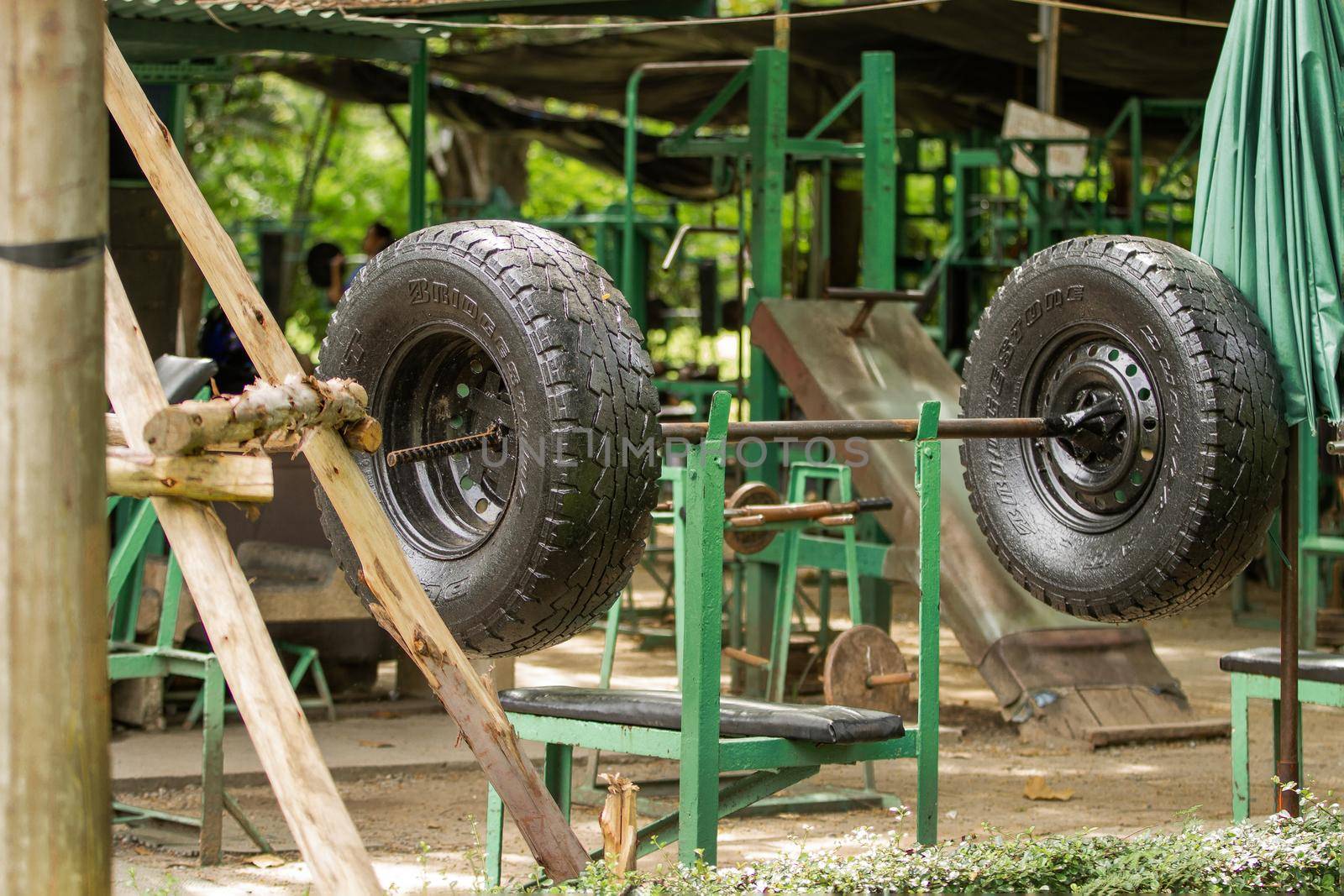 BANGKOK, THAILAND - October 23, 2012. Outdoor gym in Lumpini park. Exercise equipment made of old truck tires and metal bars.