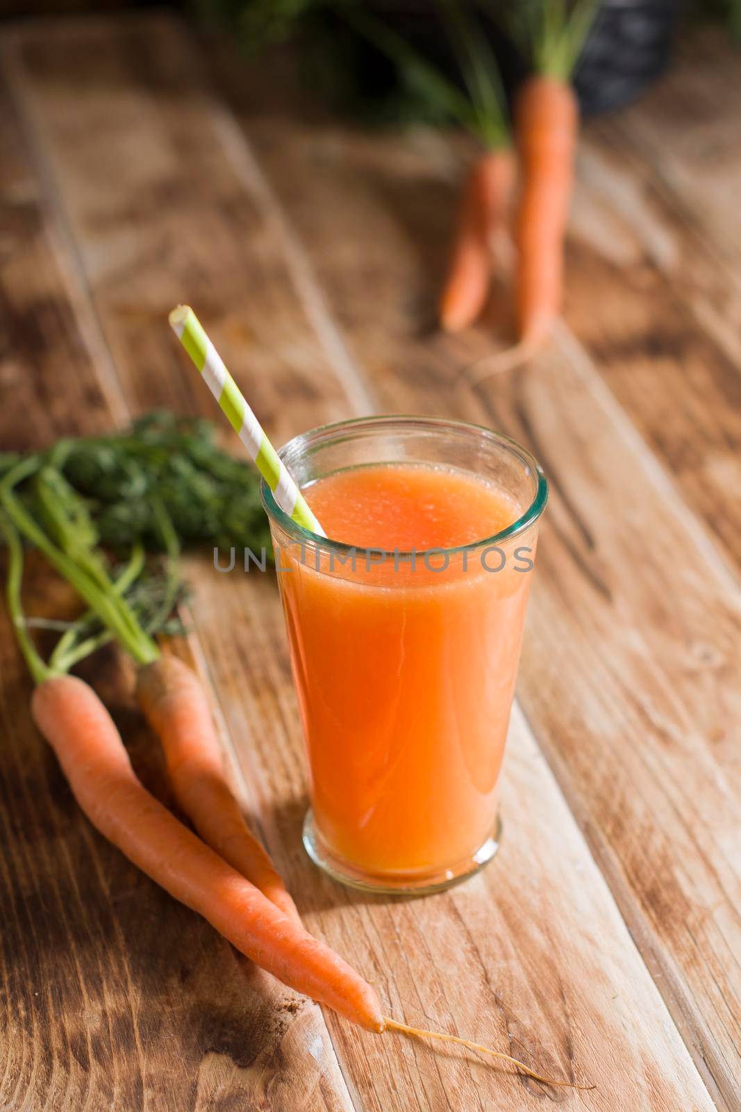 freshly squeezed carrot juice, and raw carrots, vegetarian vegetable vitamin drink, vintage still life concept, fresh carrot juice on wooden background, rustic still life