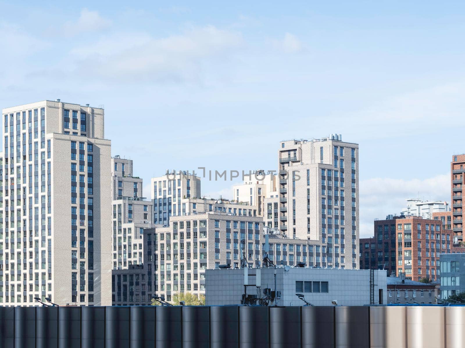 New residential district of Moscow. Modern architecture of apartment buildings. Horizontal banner with clear blue sky. Russia.