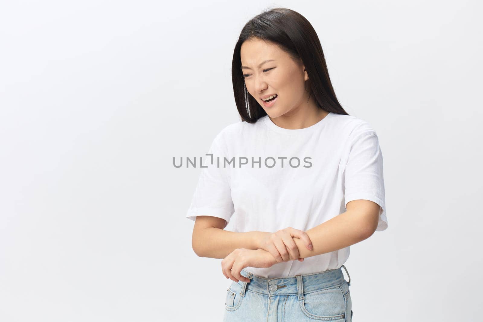 Tormented suffering from dislocation tanned beautiful young Asian woman hurting holding painful wrist posing isolated on white background. Injuries Poor health Illness concept. Cool offer Banner