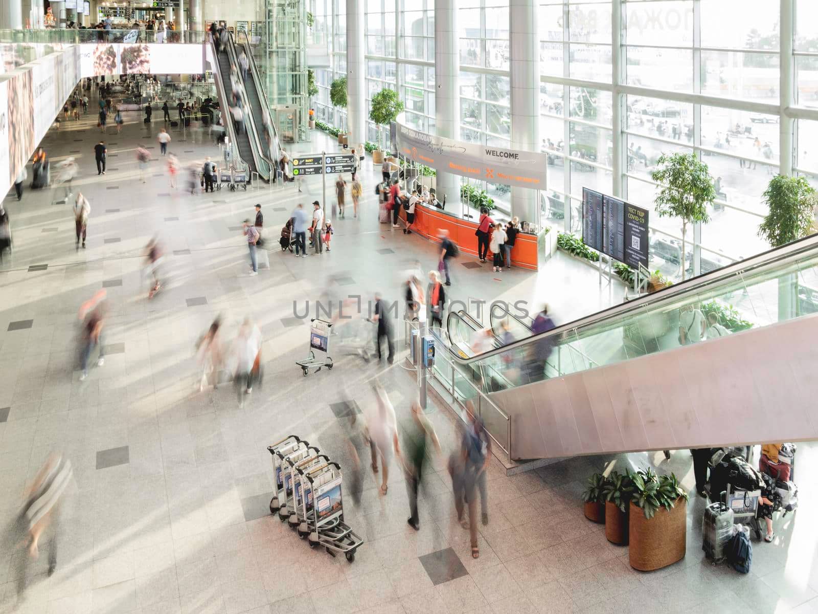MOSCOW, RUSSIA - June 28, 2021. Top view on moving people on first floor at Domodedovo airport hall. Long exposure.