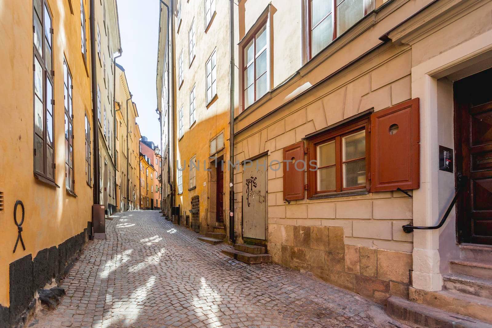 STOCKHOLM, SWEDEN - July 06, 2017. Narrow streets in historic part of town. Old fashioned buildings in Gamla stan. by aksenovko