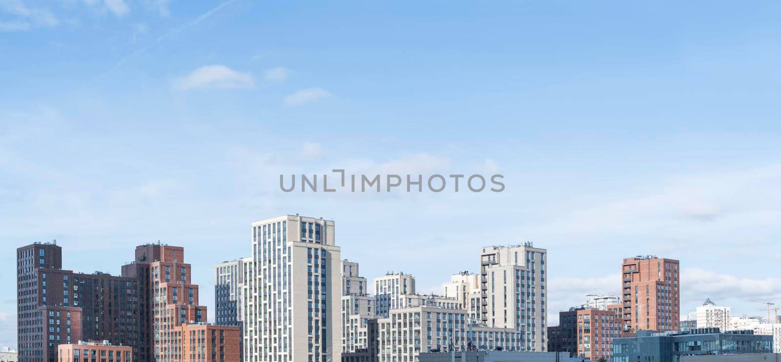 Panorama of new residential district of Moscow. Modern architecture of apartment buildings. Horizontal banner with clear blue sky. Russia.