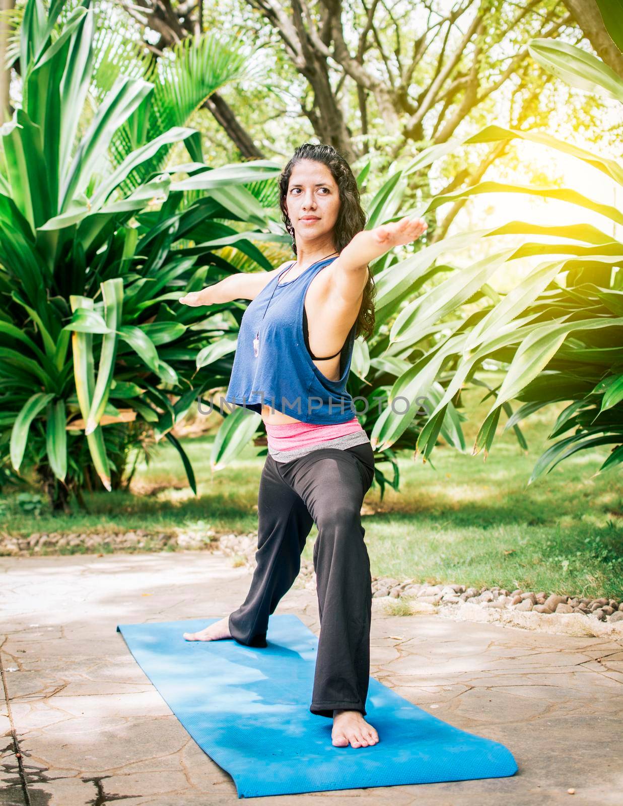 A girl doing flexibility yoga, Woman doing yoga outdoors, young girl showing yoga styles outdoors, yoga and fitness concept