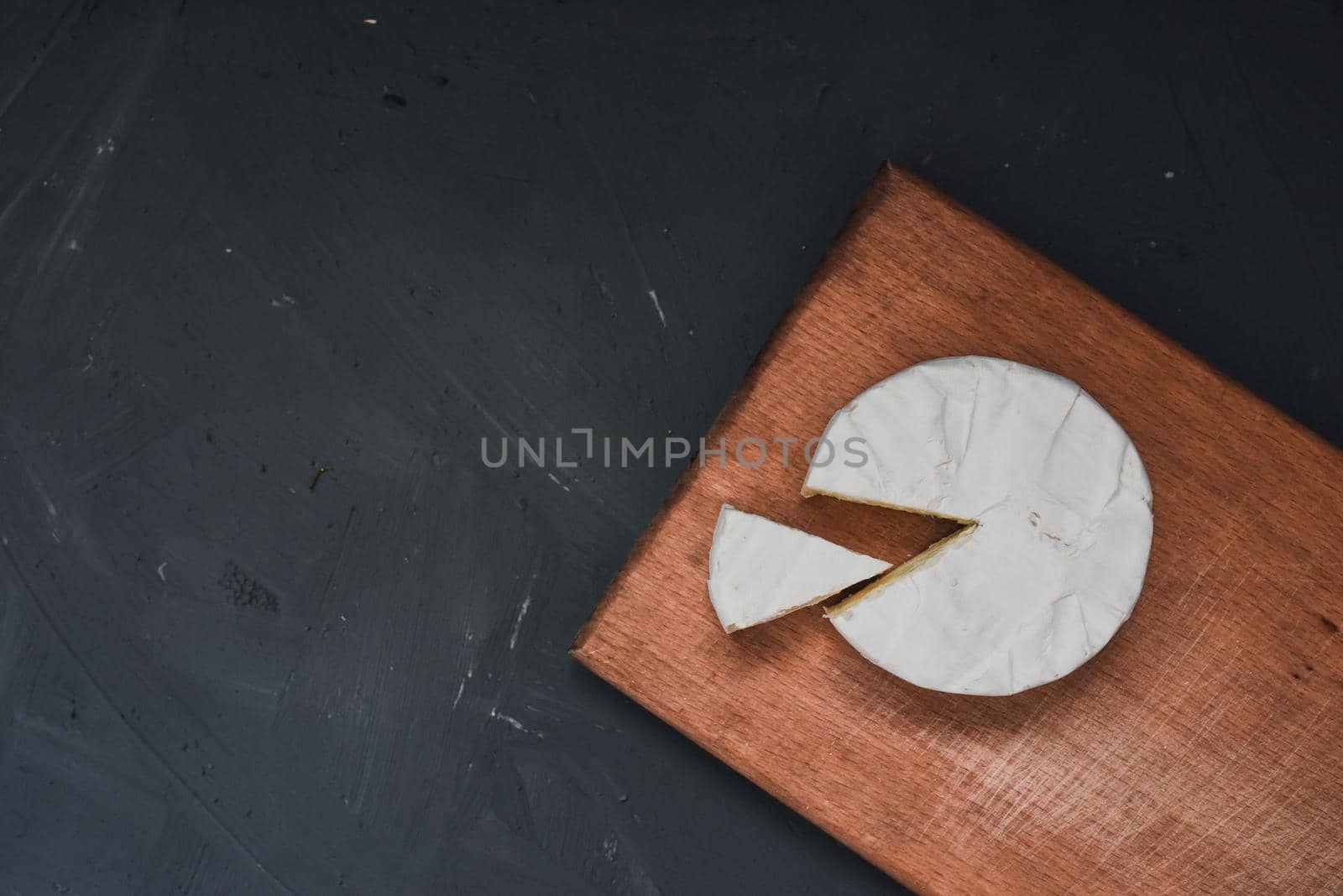 cheese camembert with mold on the wooden cutting board