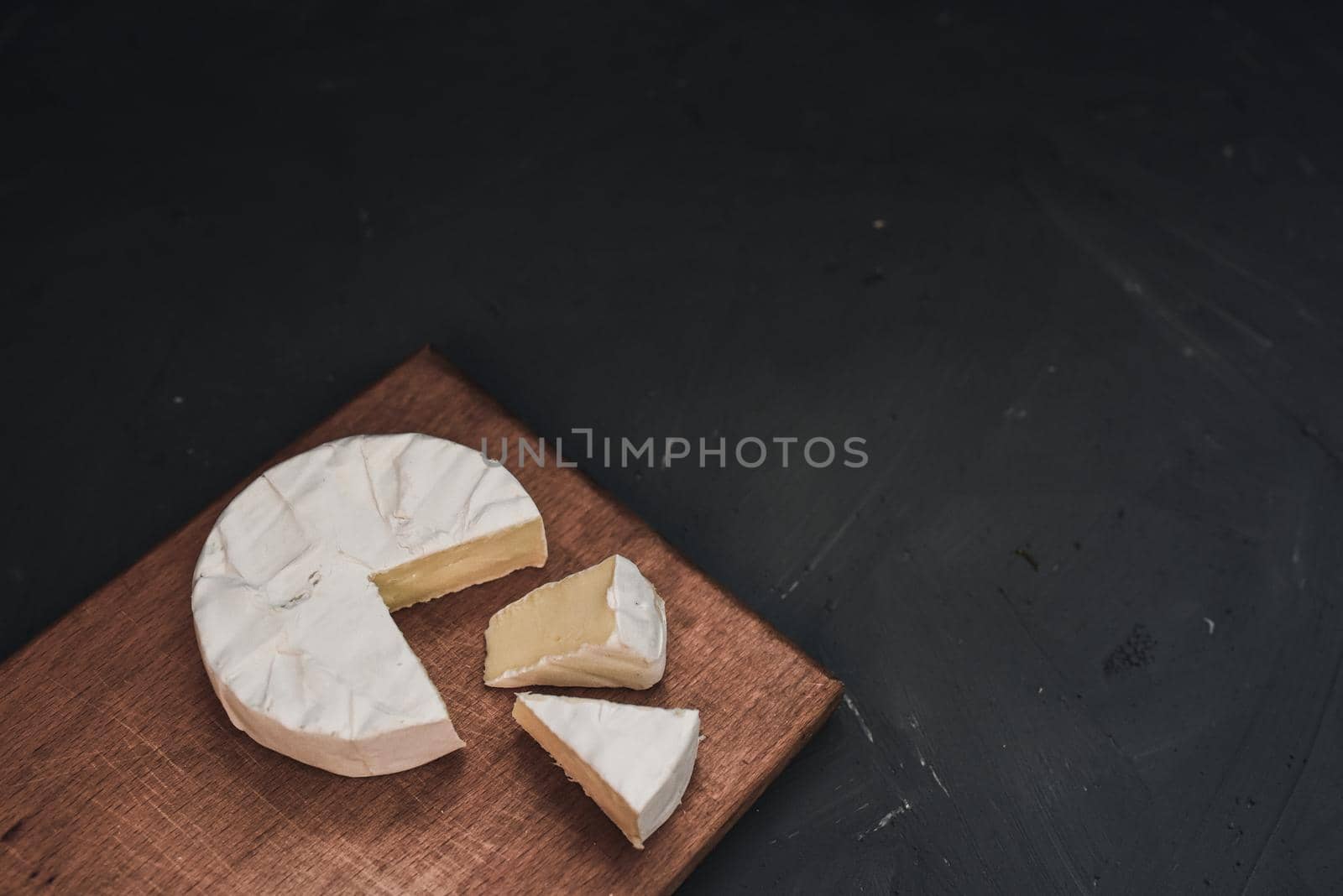 cheese camembert with mold on the wooden cutting board