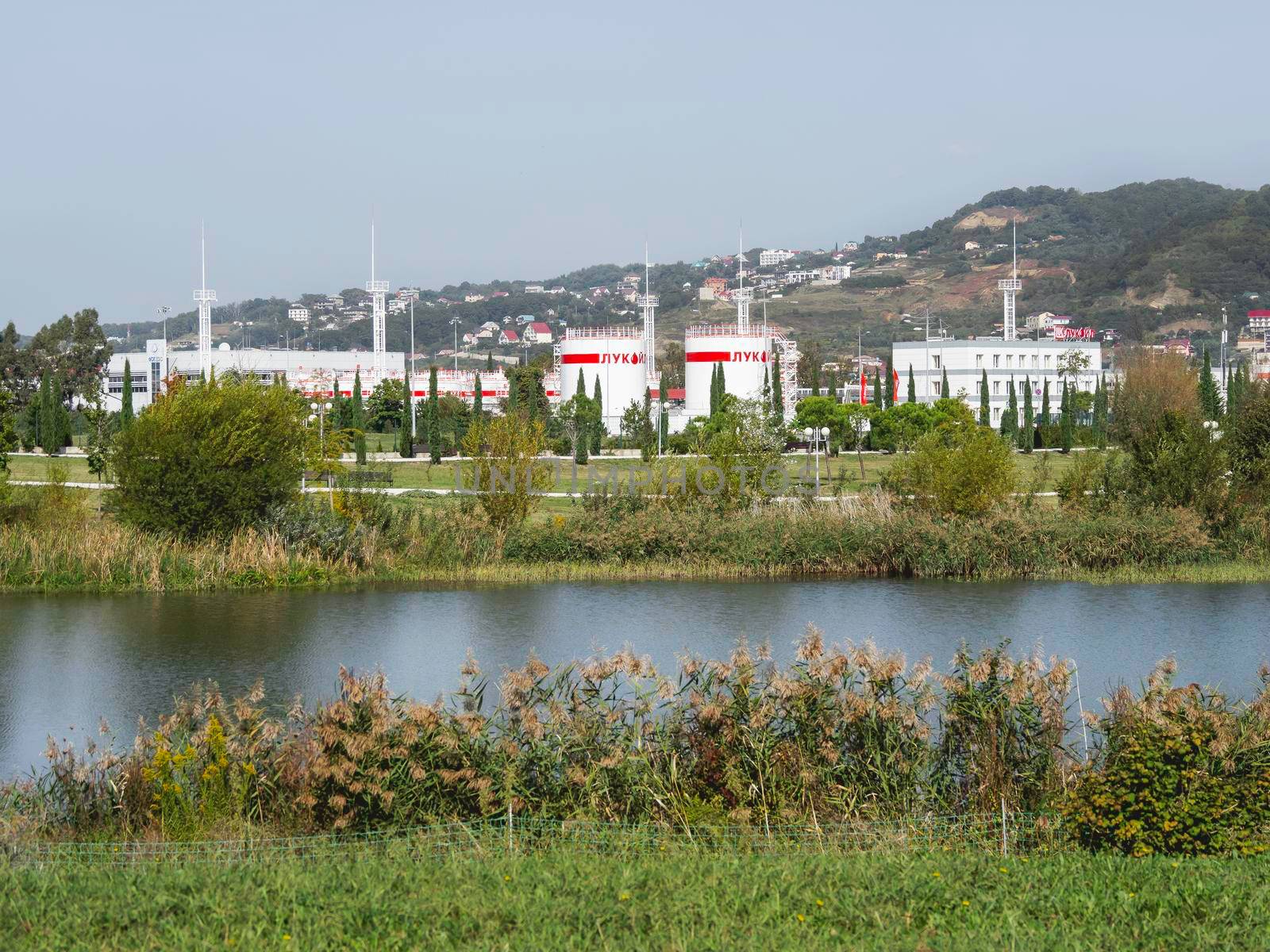 SOCHI, RUSSIA - October 11, 2018. Petroleum storage depot of Lukoil company. White buildings and red flags of of oil base.