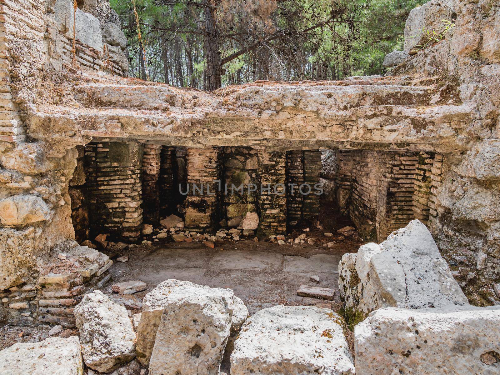 Ruins of large bath in ancient Phaselis city. Famous architectural landmark, Kemer district. Turkey. by aksenovko