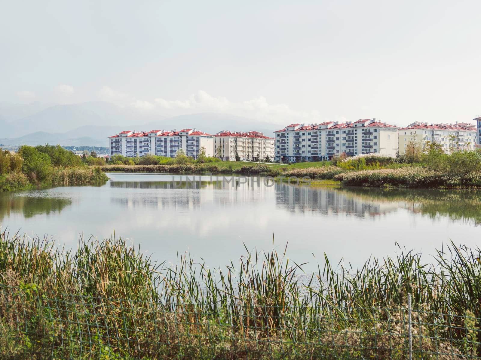 Low - rise apartment buildings in new neighbourhood. Quarters of newly built houses for sale. Adler district of Sochi, Russia. by aksenovko