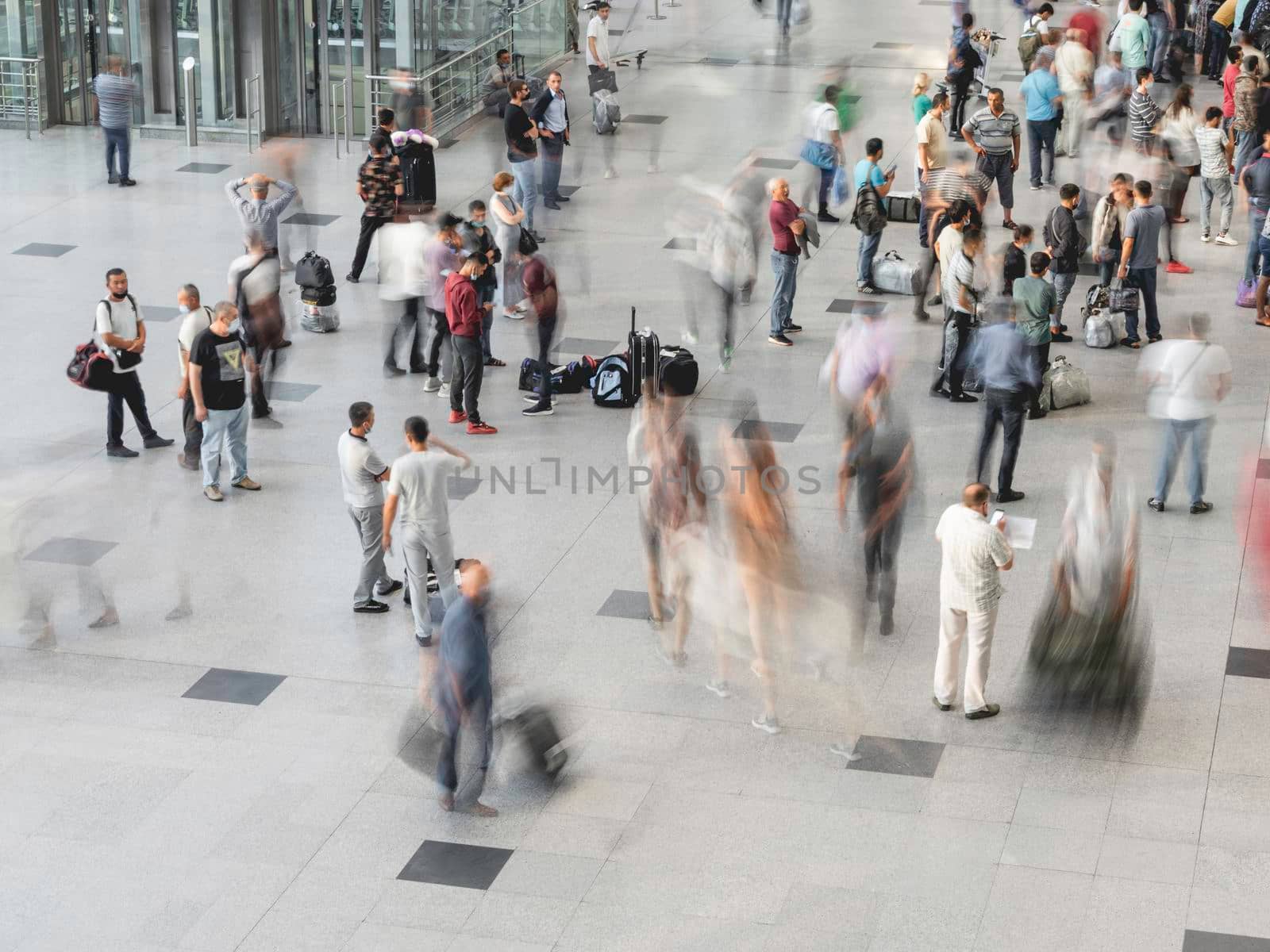 MOSCOW, RUSSIA - June 28, 2021. Moving people on first floor at Domodedovo airport hall. Long exposure.