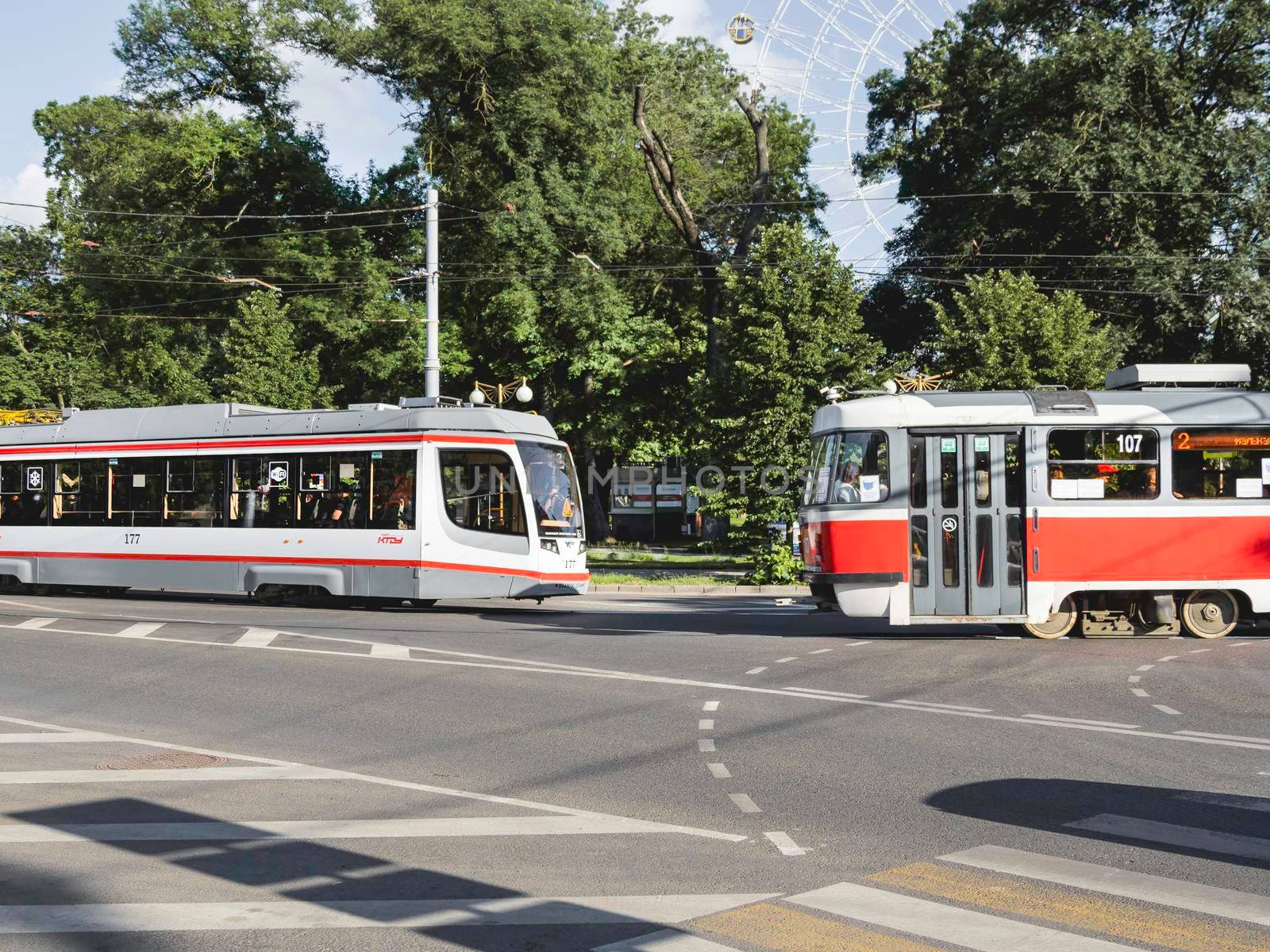 KRASNODAR, RUSSIA - June 02, 2021. Old and modern trams meet each other on urban road of Krasnodar. by aksenovko