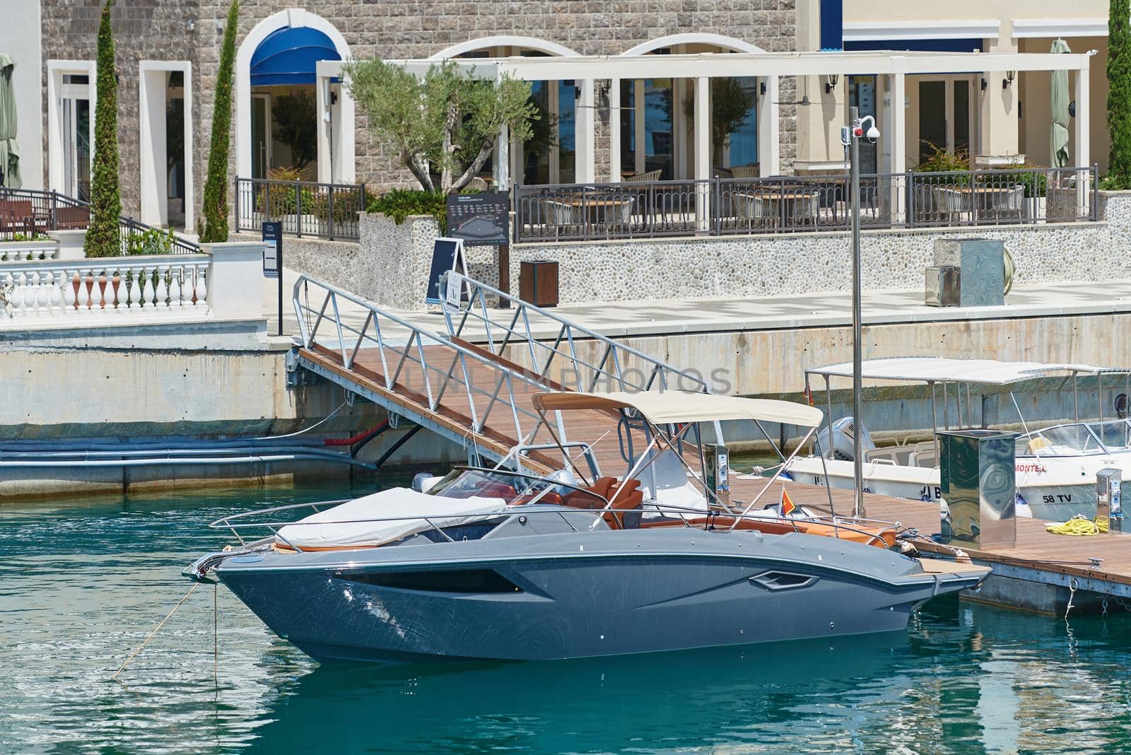 Small yacht of gray color moored at dock.