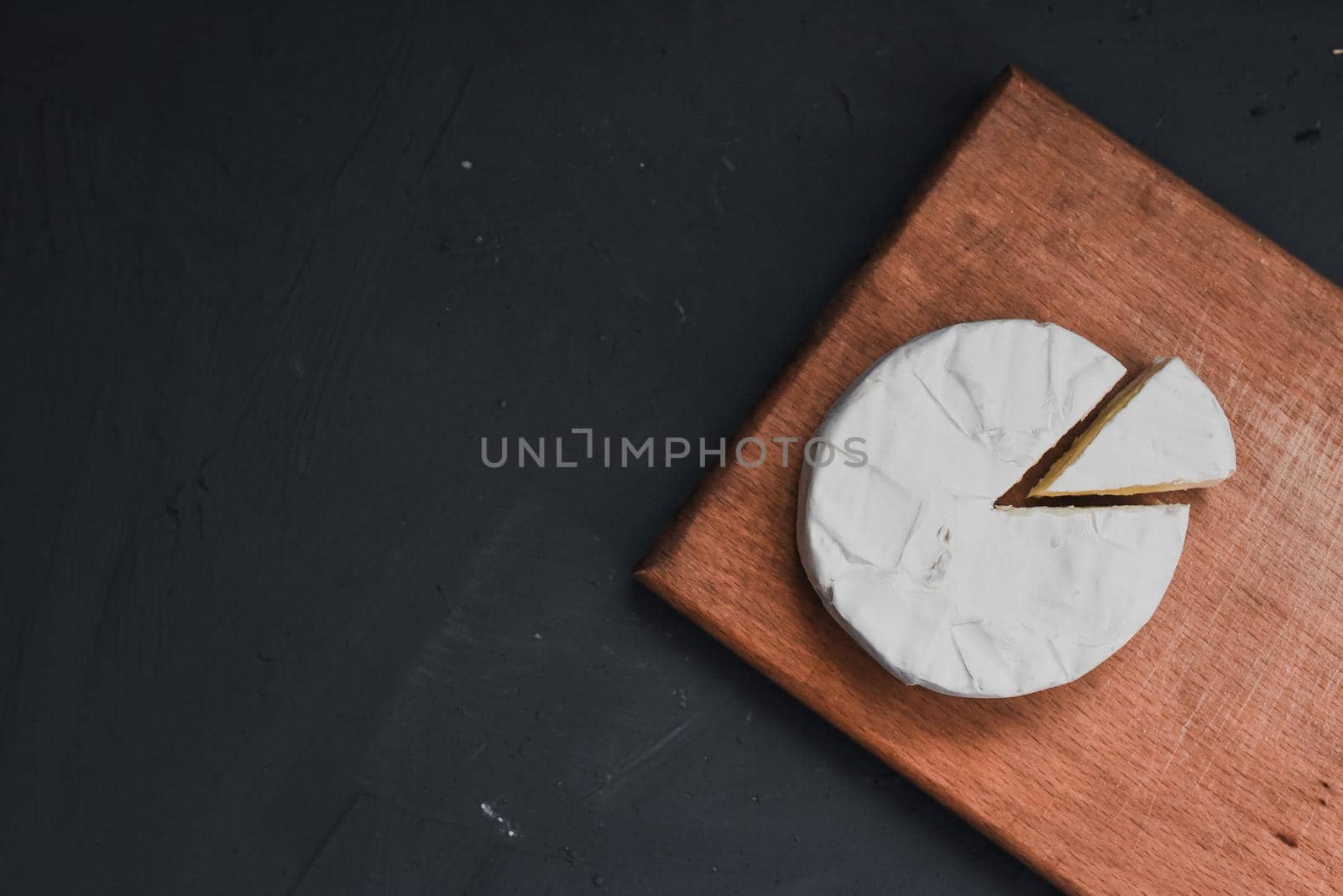 cheese camembert with mold on the wooden cutting board