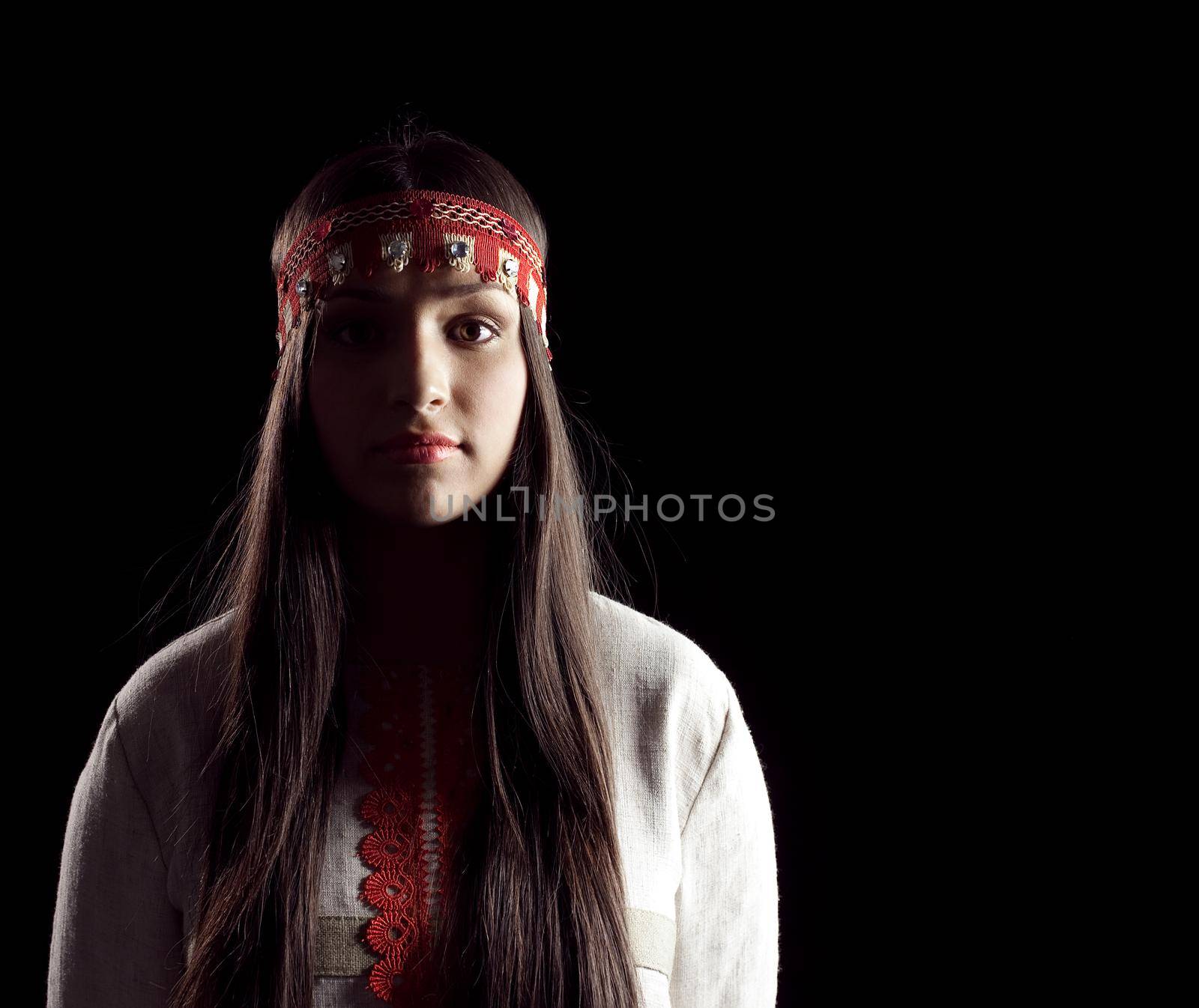 Young beauty girl in dark - oriental russian costume