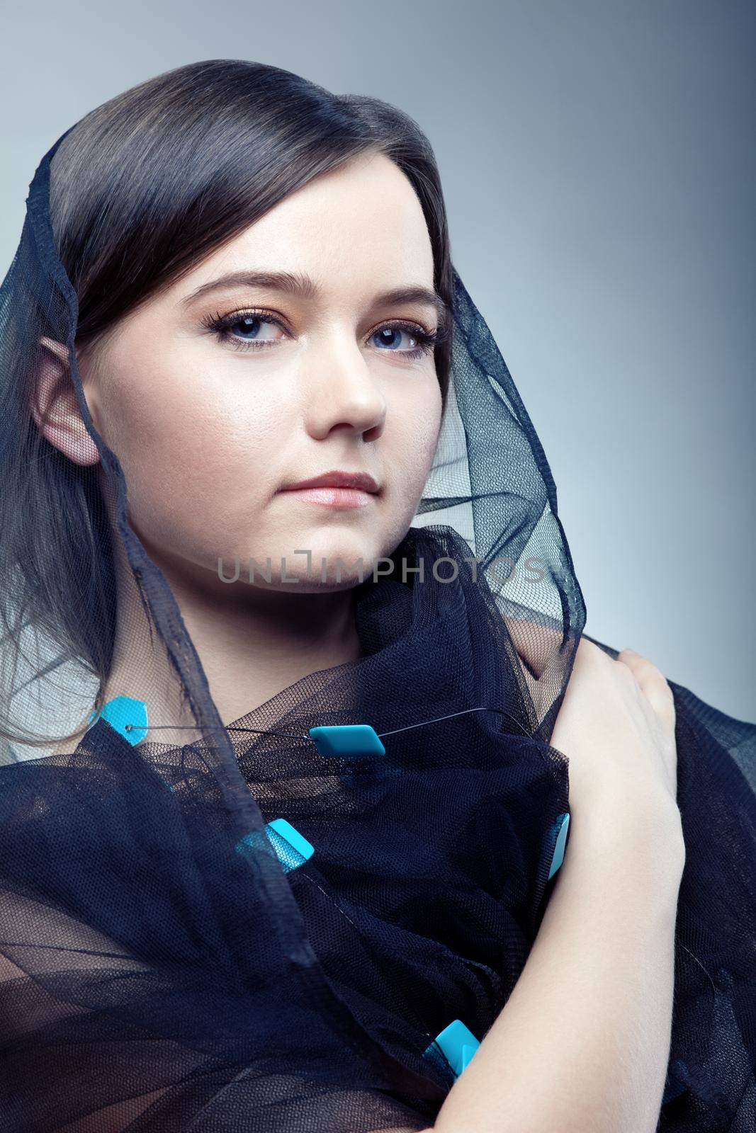 Young serious woman in pretty veil - close-up portrait