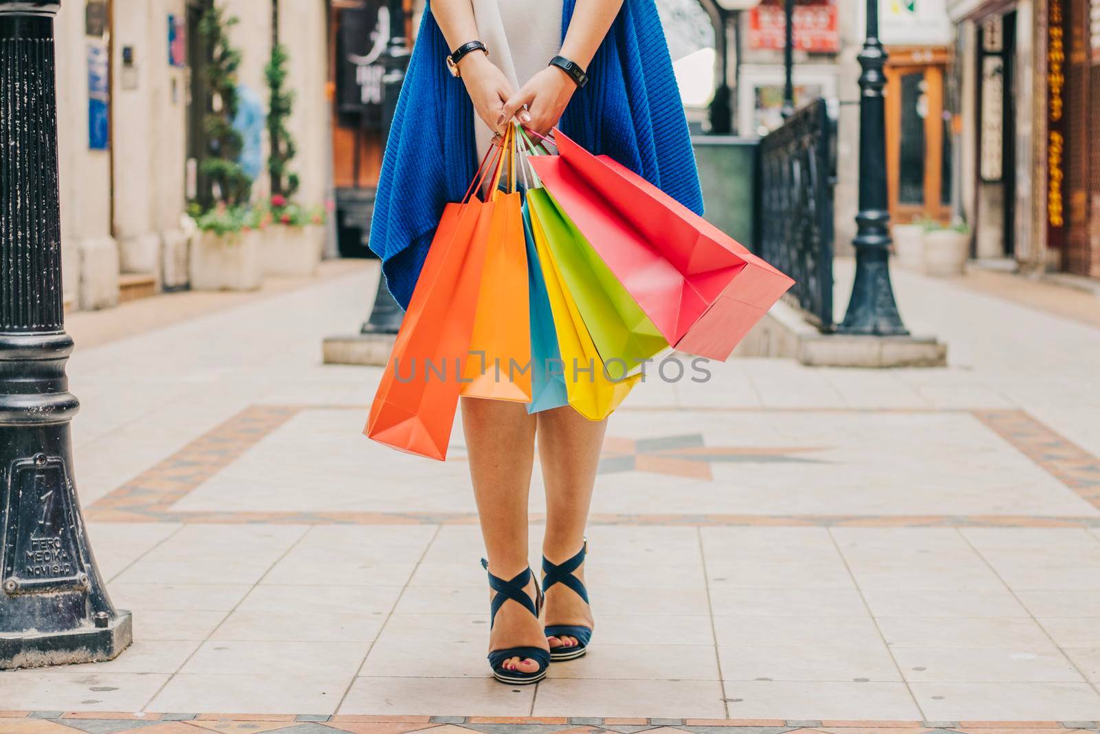 unrecognizable woman with shopping bags