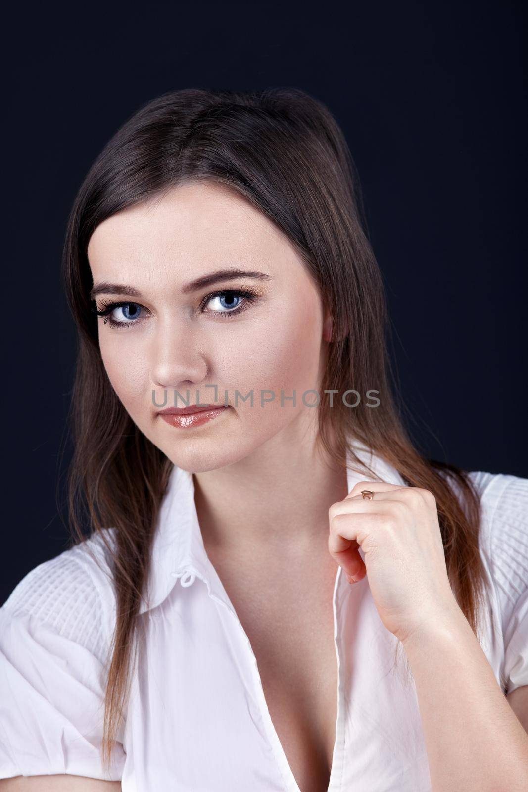 Serious young brunette woman look at you