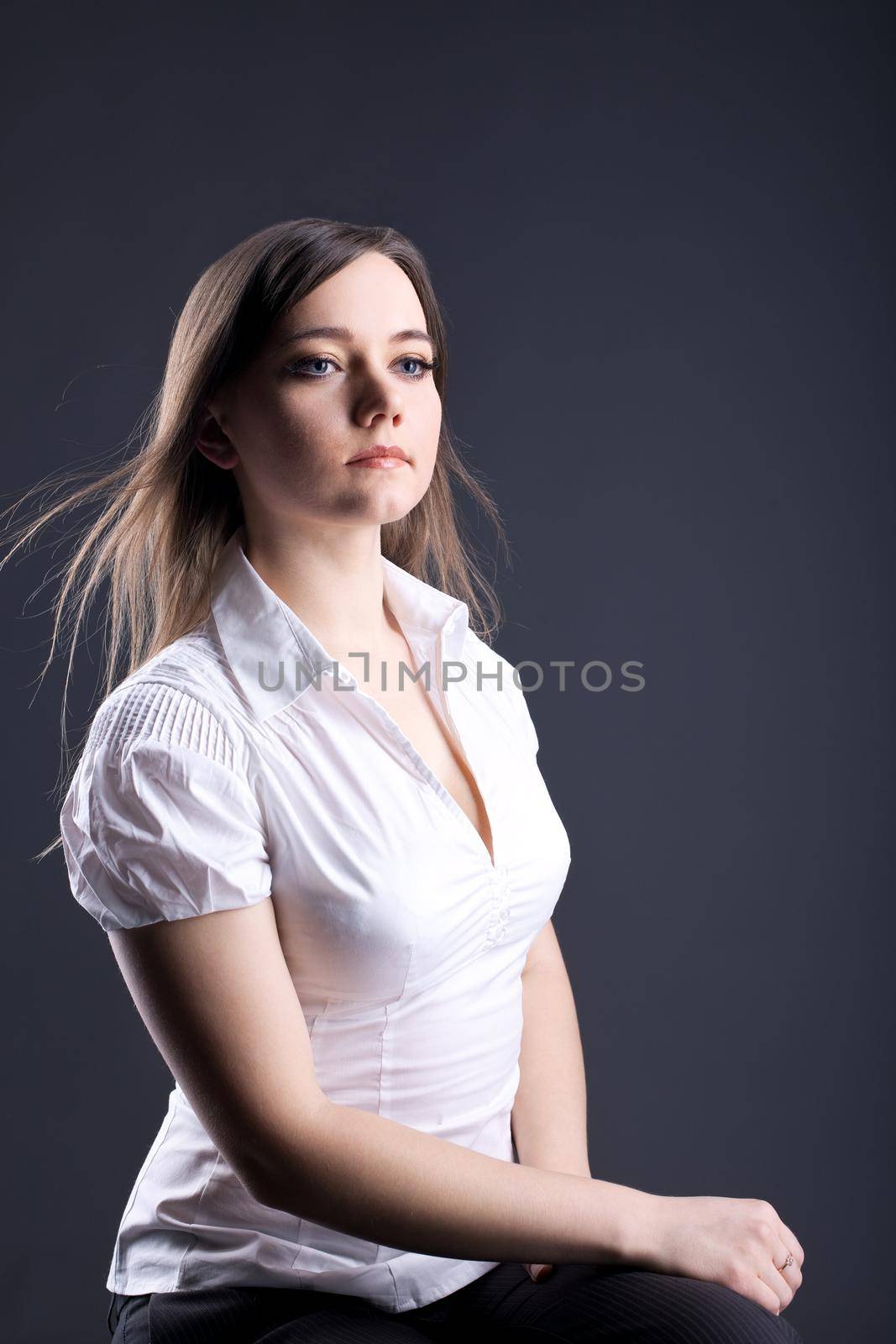 Young proud woman - serious business portrait look in future