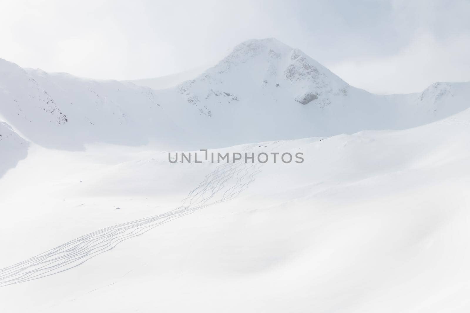 winter landscape, snow-capped mountains, the Caucasian ridge and traces from skiers and snowboarders